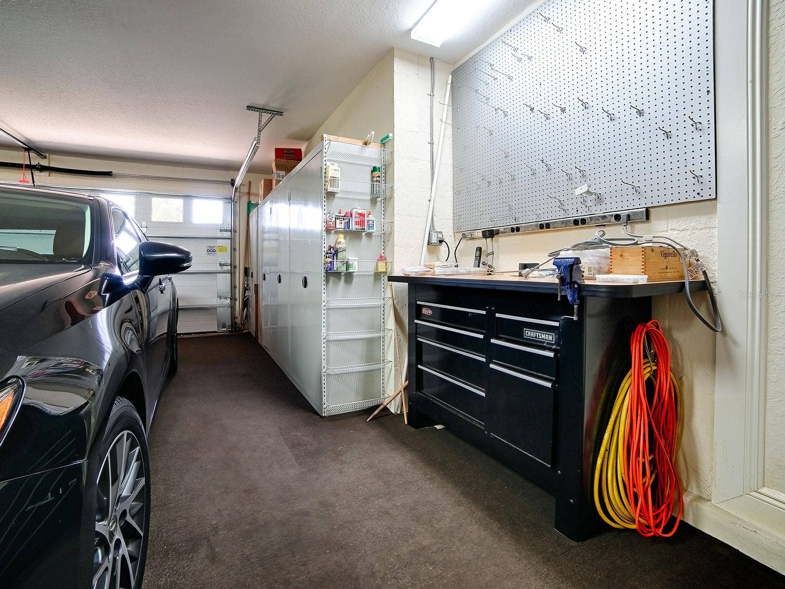 LOTS A CABINET SPACE AND INSULATED GARAGE DOORS FOR A COMFORTABLE WORK SPACE
