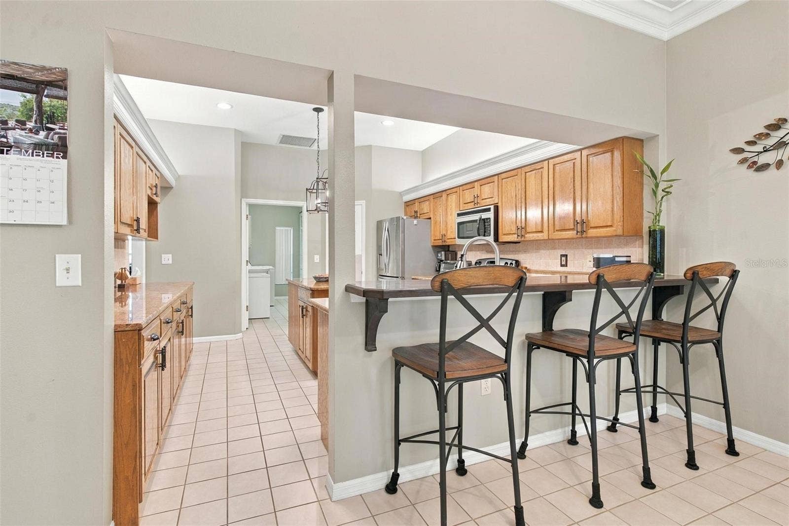 8732 SPRING COURT, Leesburg, FL 34788 Kitchen features bar to eat at.