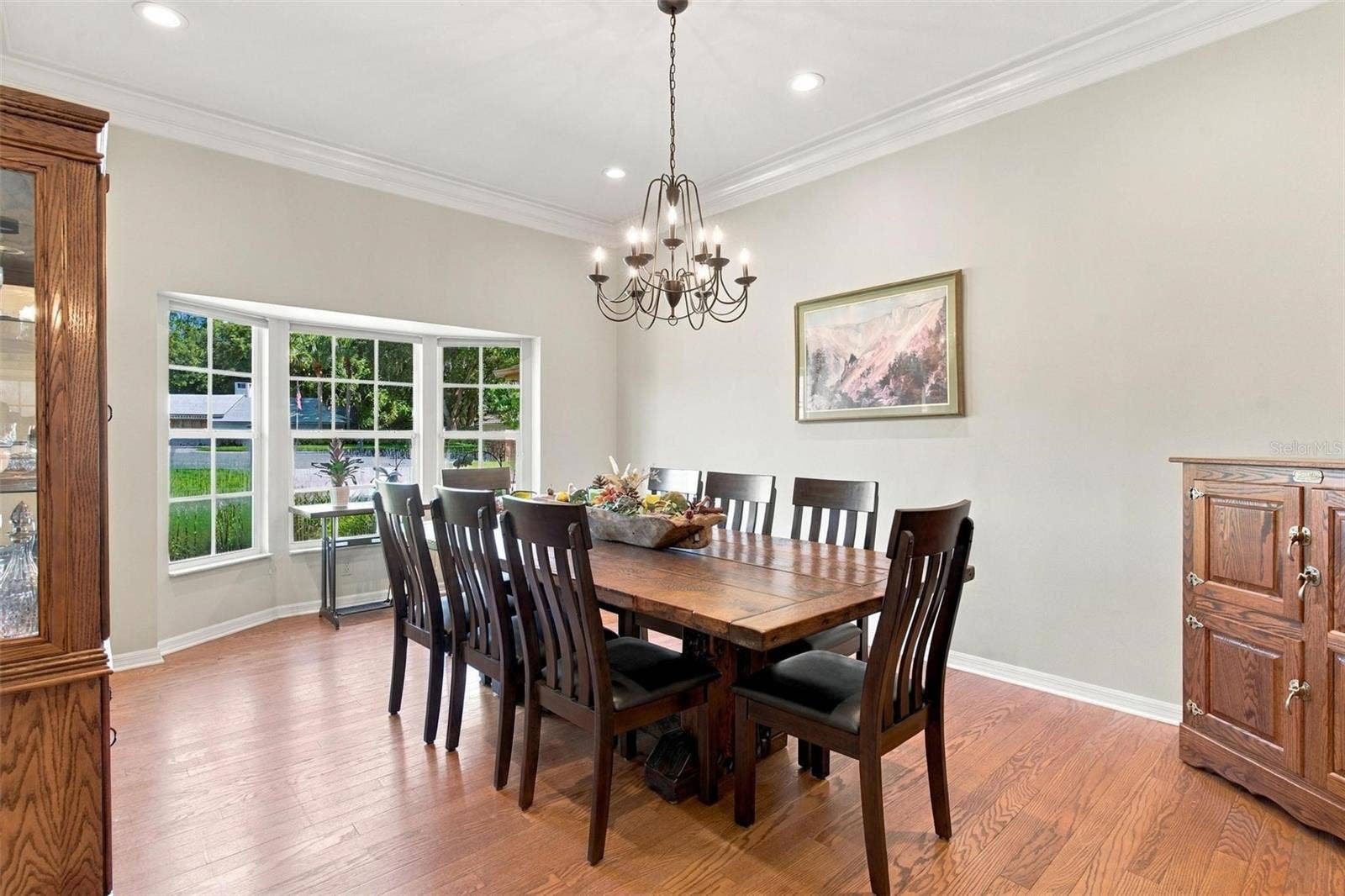 8732 SPRING COURT, Leesburg, FL 34788 Formal Dining Area features wood flooring, bay windows, and overlooks Family Room