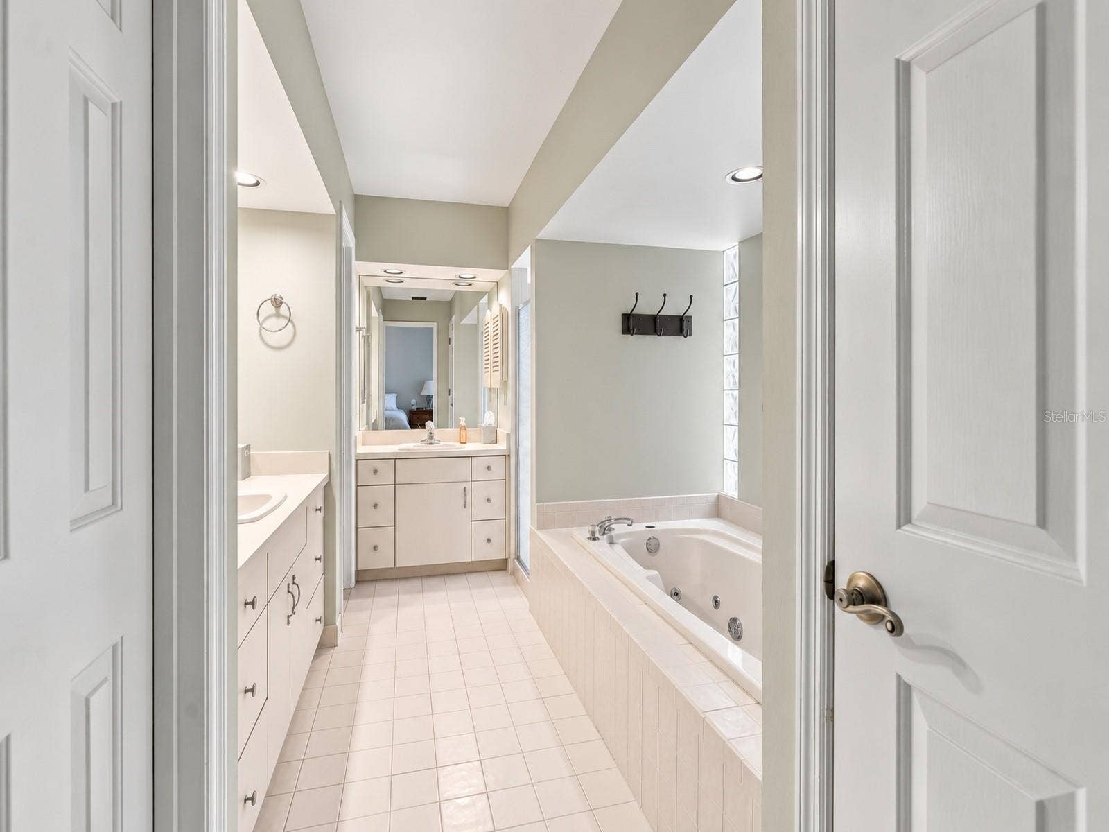 8732 SPRING COURT, Leesburg, FL 34788 Primary Bathroom features 2 vanities, jacuzzi tub, walk in closets, and shower.