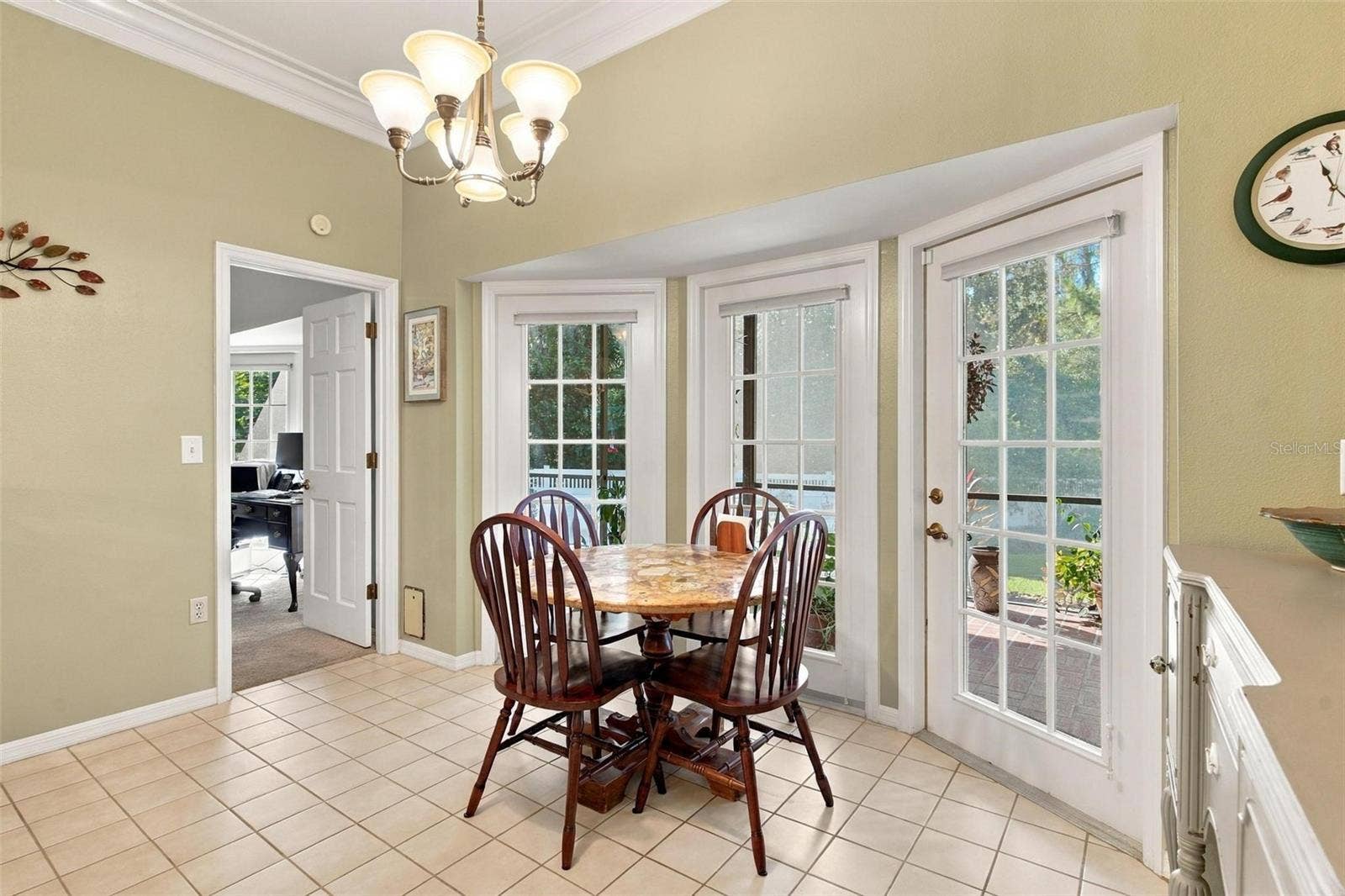 8732 SPRING COURT, Leesburg, FL 34788 Kitchen Dinette overlooks kitchen and has French doors leading to screened enclosed lanai.