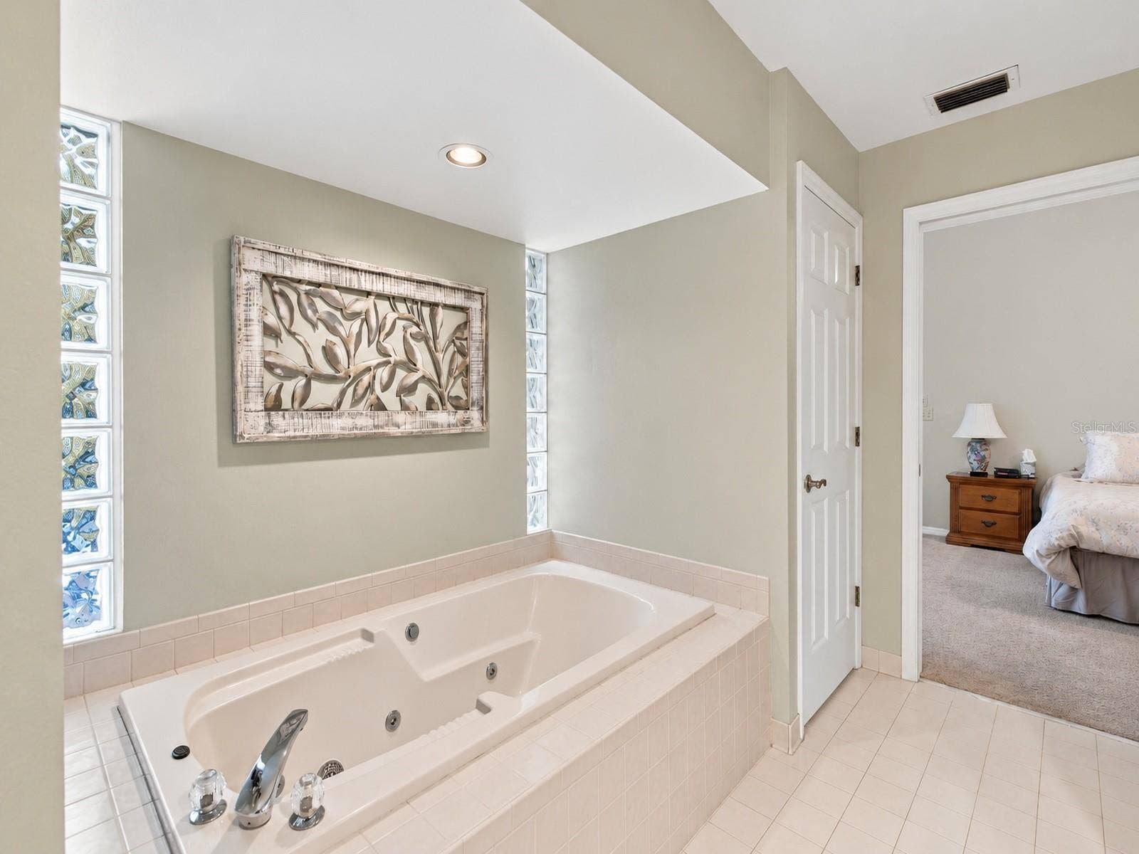 8732 SPRING COURT, Leesburg, FL 34788 Primary Bathroom features 2 vanities, jacuzzi tub, walk in closets, and shower.