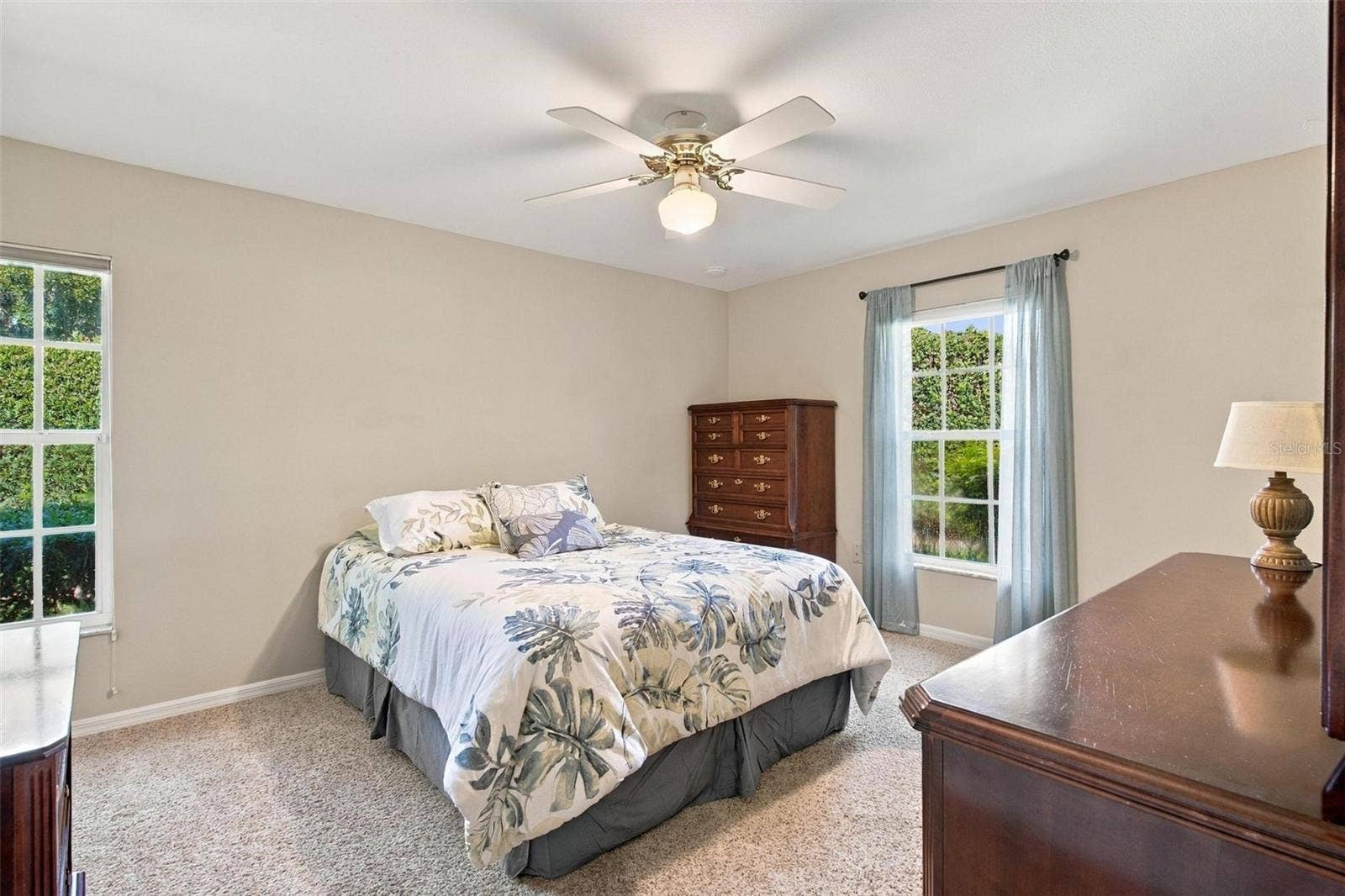 8732 SPRING COURT, Leesburg, FL 34788 Split floor plan-Bedroom #2 features carpet and walk in closet.