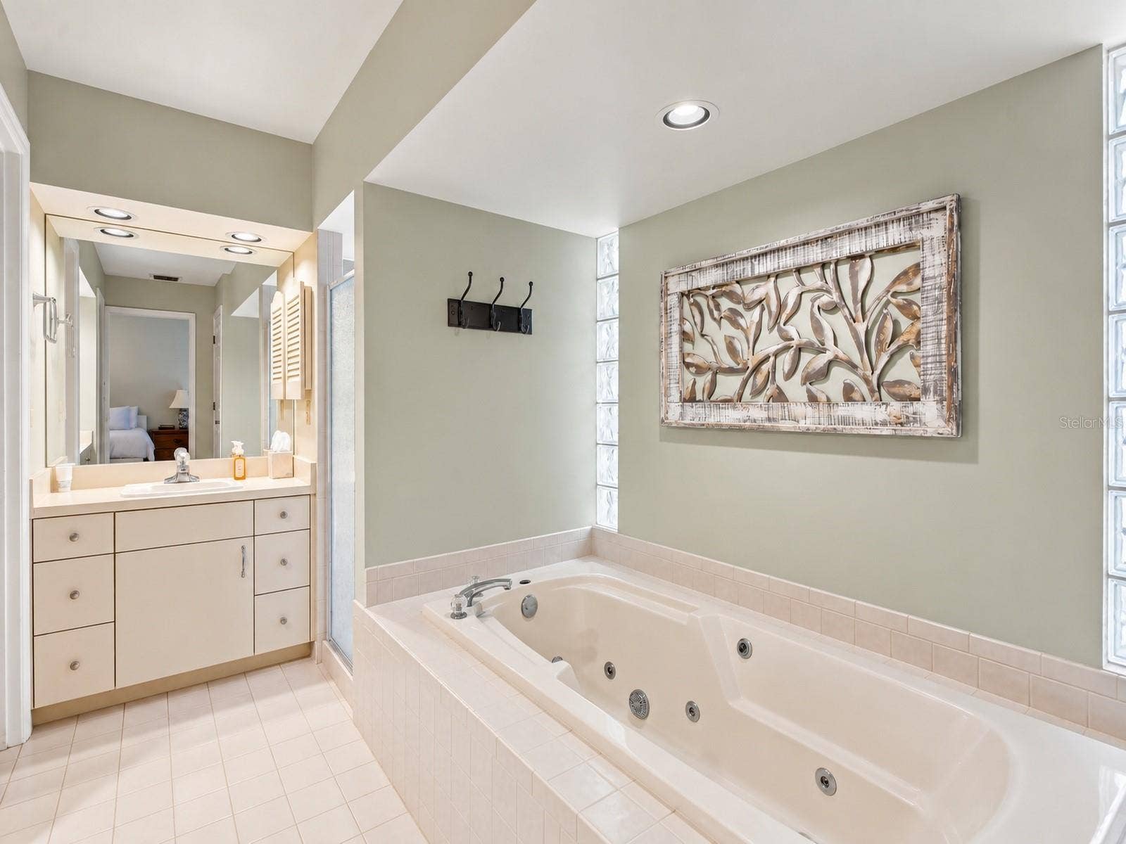 8732 SPRING COURT, Leesburg, FL 34788 Primary Bathroom features 2 vanities, jacuzzi tub, walk in closets, and shower.