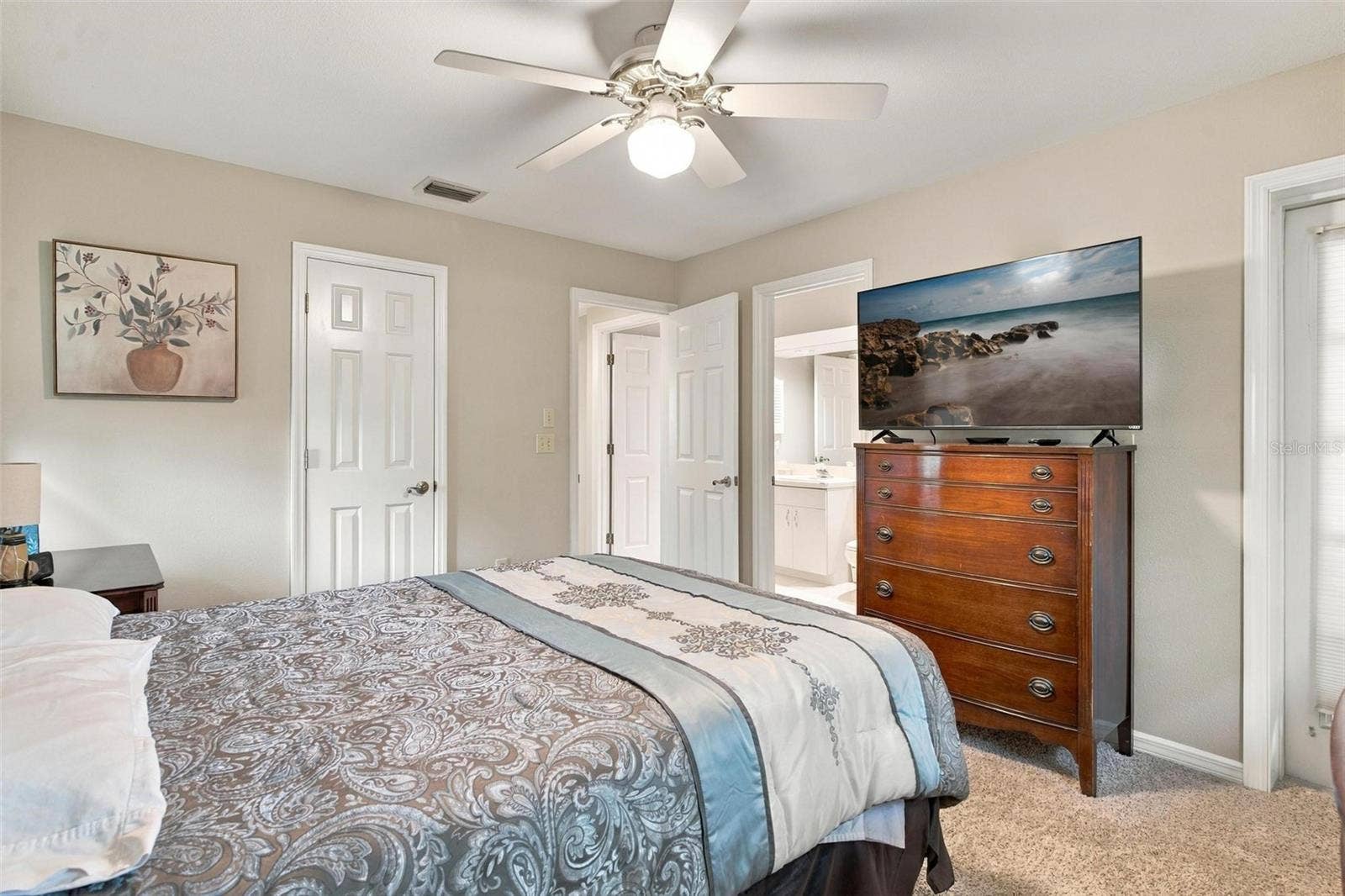 8732 SPRING COURT, Leesburg, FL 34788 Split Floor Plan-Bedroom #3 features carpet, door leading to lanai and door leading to private entry into bathroom.