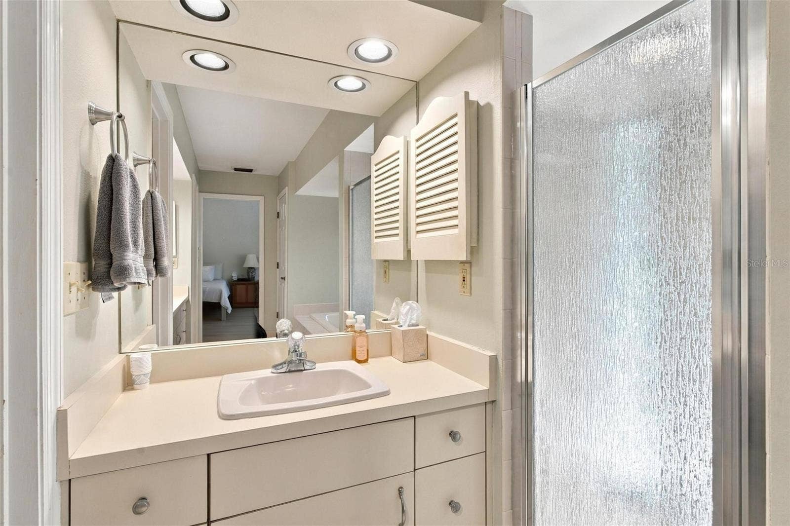 8732 SPRING COURT, Leesburg, FL 34788 Primary Bathroom features 2 vanities, jacuzzi tub, walk in closets, and shower.
