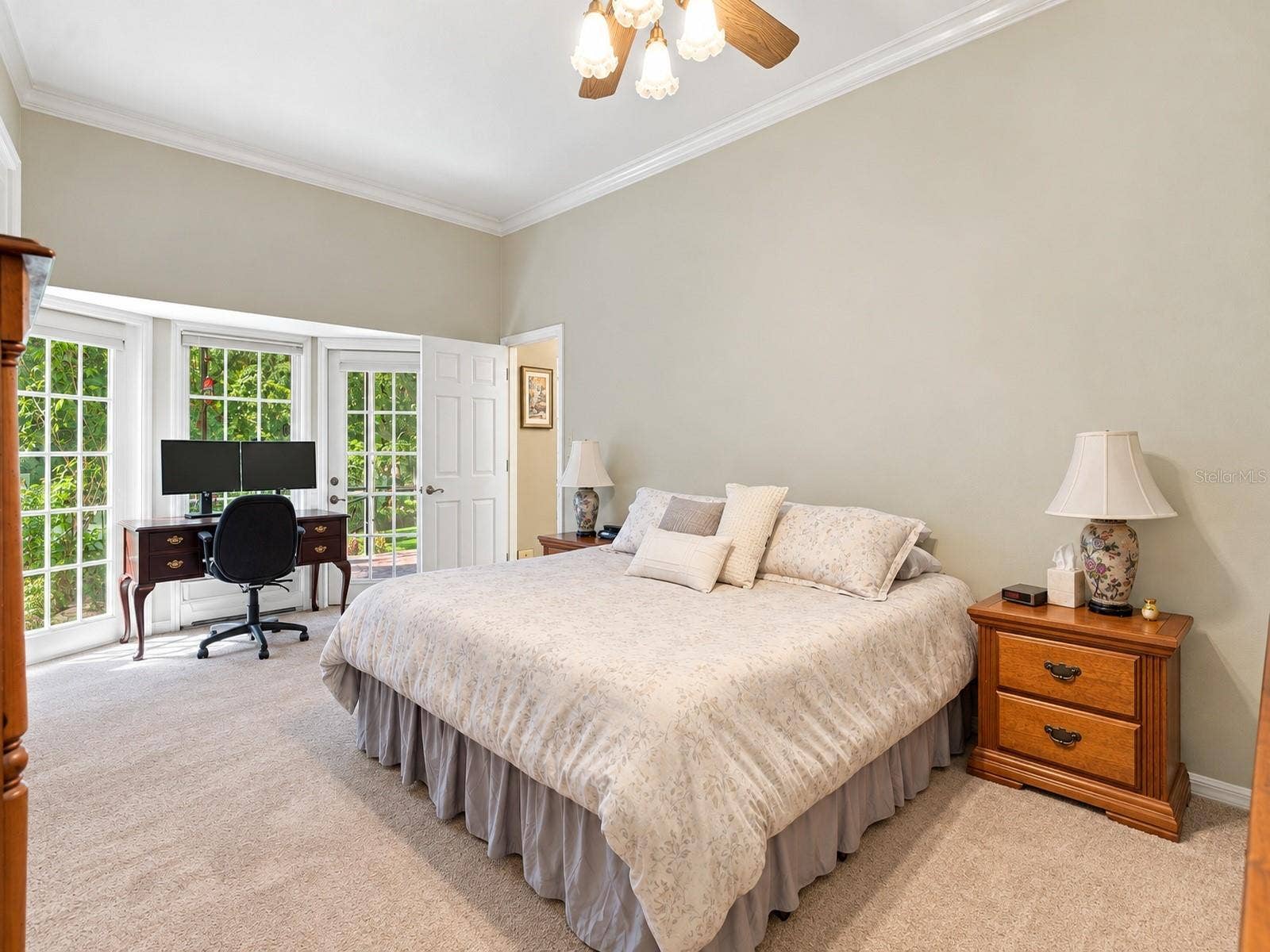 8732 SPRING COURT, Leesburg, FL 34788 Primary Bedroom features high ceilings, carpet, lots of natural light, and door leading to back patio