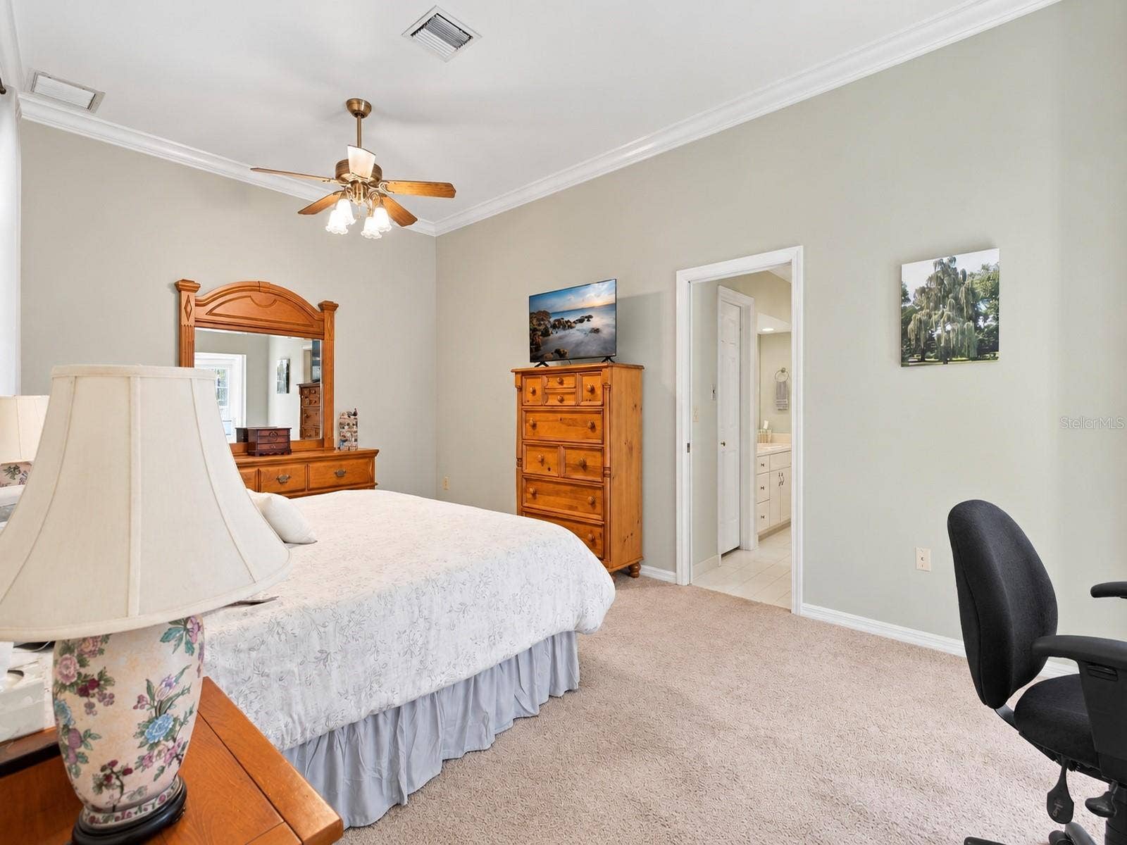 8732 SPRING COURT, Leesburg, FL 34788 Primary Bedroom features high ceilings, carpet, lots of natural light, and door leading to back patio
