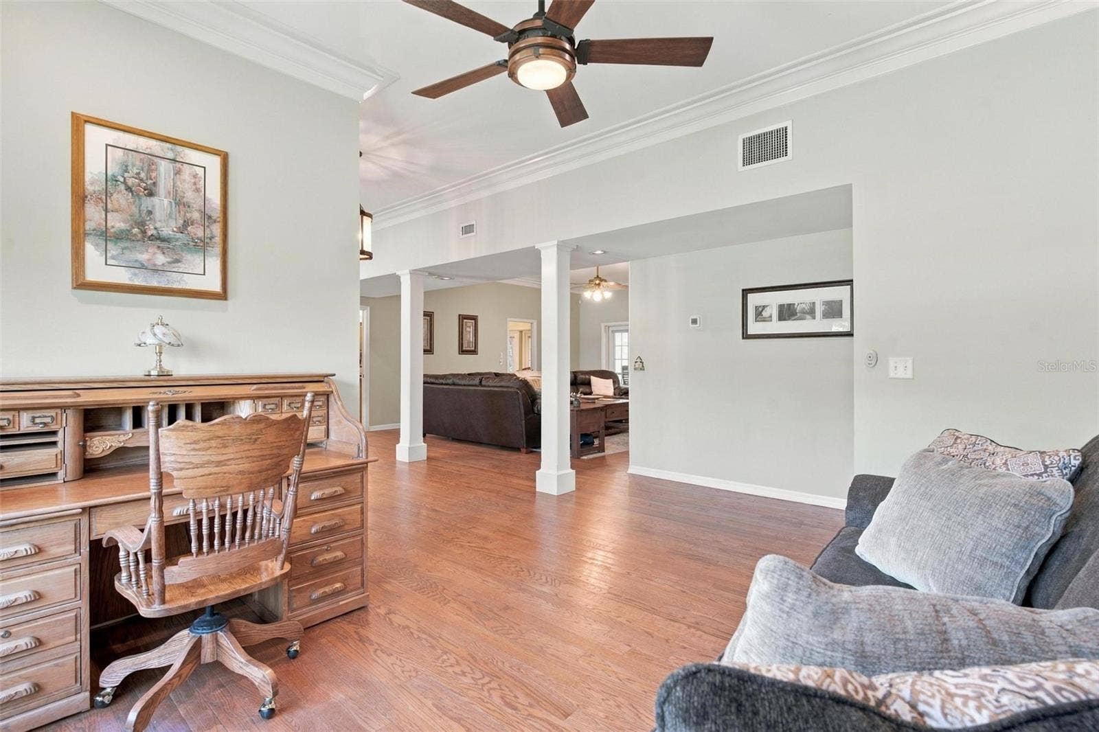 8732 SPRING COURT, Leesburg, FL 34788 Formal Living Area features wood flooring, bay windows, and overlooks Family Room.