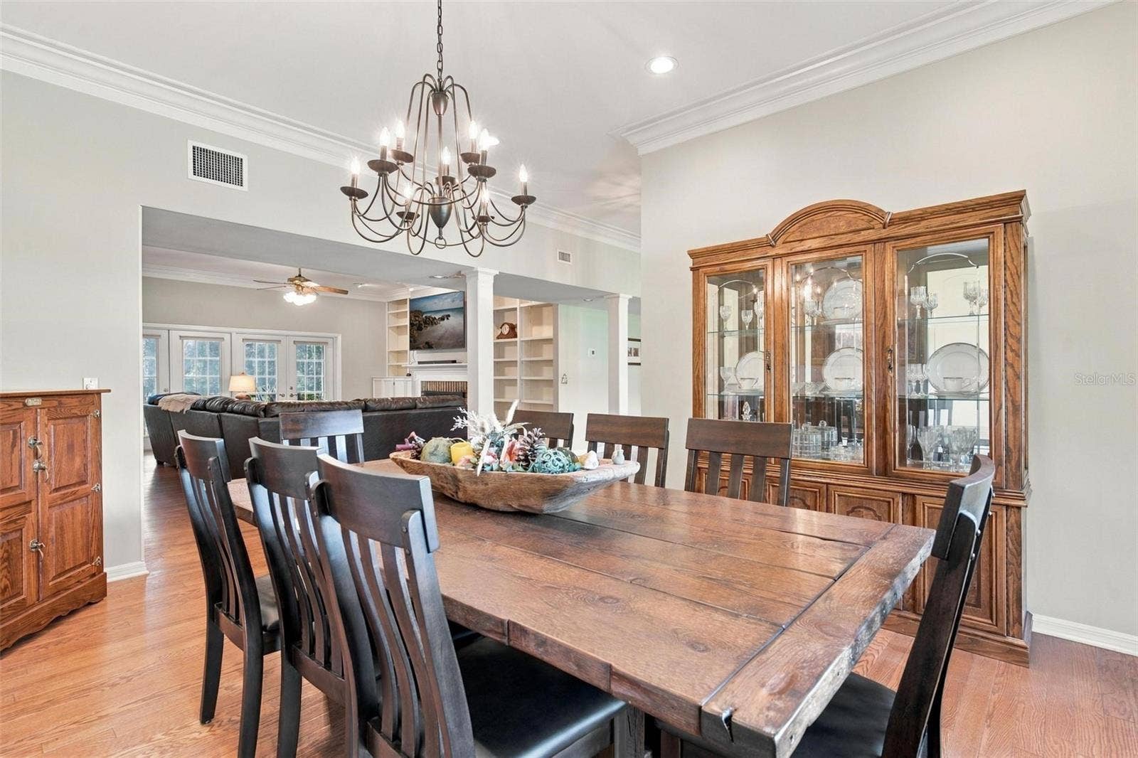 8732 SPRING COURT, Leesburg, FL 34788 Formal Dining Area features wood flooring, bay windows, and overlooks Family Room