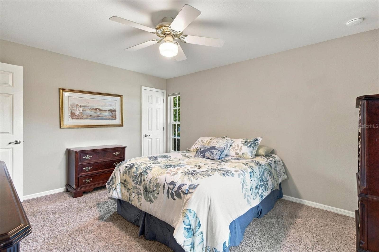 8732 SPRING COURT, Leesburg, FL 34788 Split floor plan-Bedroom #2 features carpet and walk in closet.
