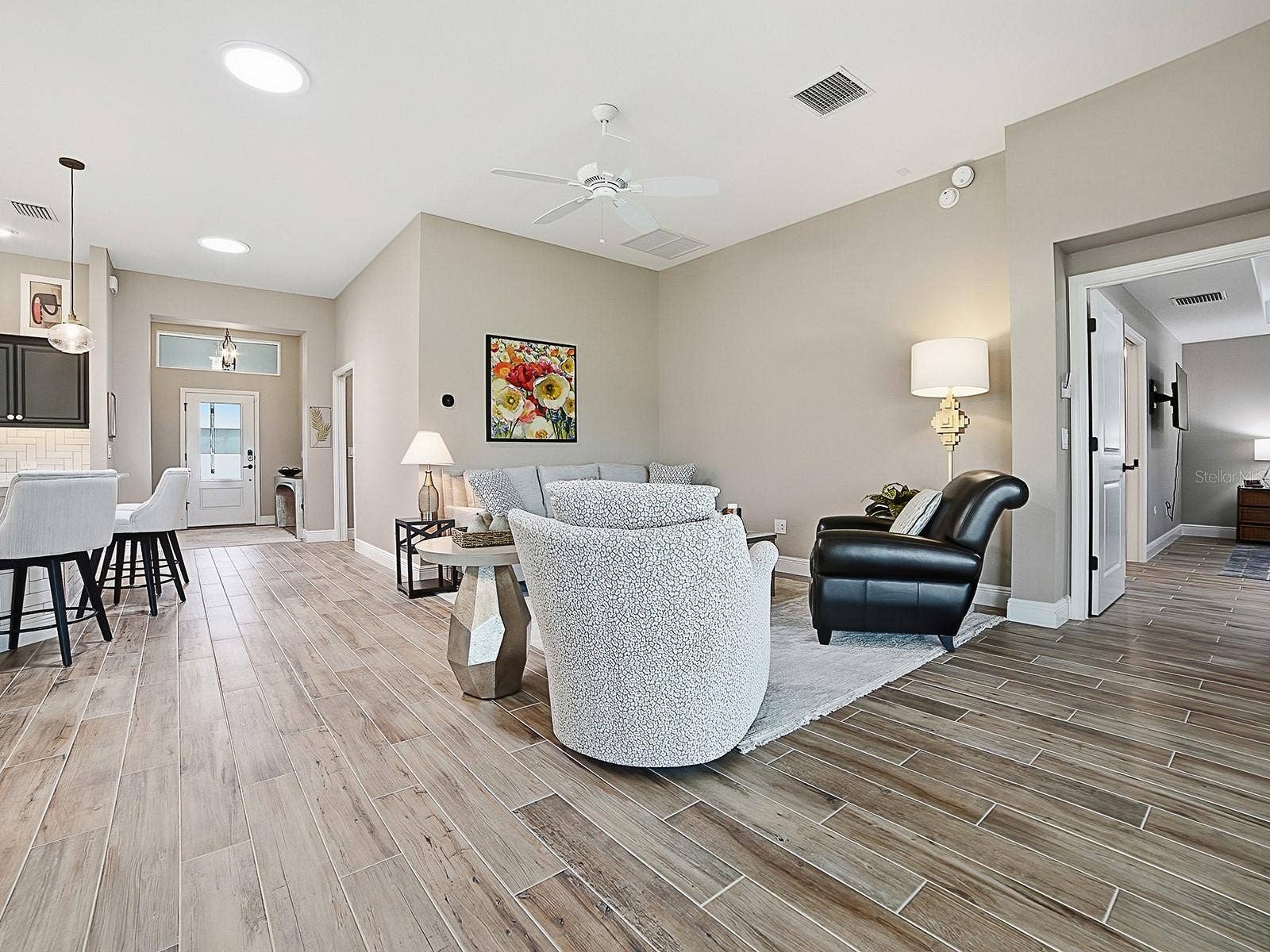 3075 LICCIARDELLO PATH, The Villages, FL 32163 OPEN FLOOR PLAN WITH SOLAR TUBES THROUGHOUT THE HOME FOR NATURAL LIGHTING. THE POCKET DOOR TO THE RIGHT LEADS TO ANOTHER GUEST SUITE AND LAUNDRY. THE KITCHEN IS TO THE LEFT.
