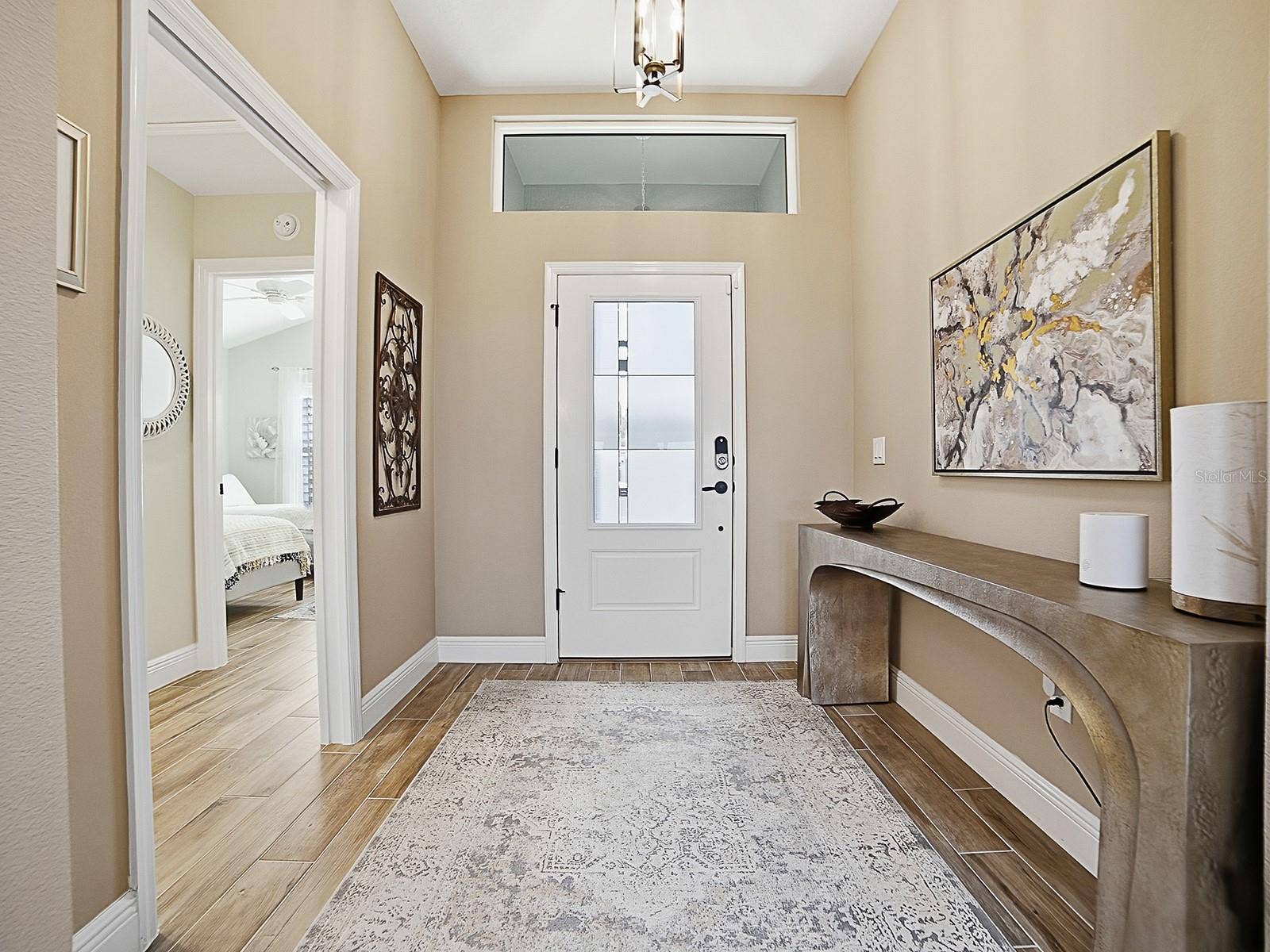 3075 LICCIARDELLO PATH, The Villages, FL 32163 WOOD-LOOK PORCELAIN TILE FLOWS THROUGHOUT THE HOME! NICE LARGE FOYER WITH A POCKET DOOR THAT LEADS TO ONE OF THE GUEST SUITES.