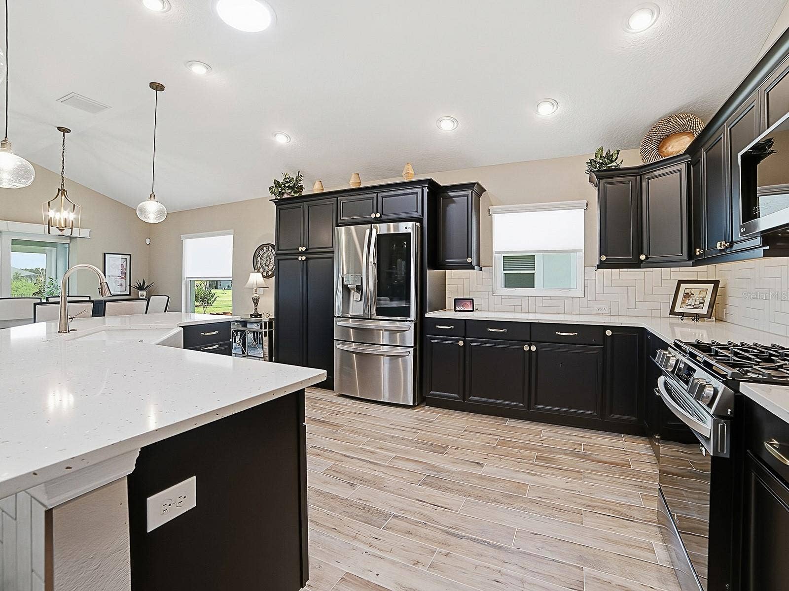 3075 LICCIARDELLO PATH, The Villages, FL 32163 WHAT A BEAUTIFUL KITCHEN! QUARTZ COUNTERTOPS, STAINLESS APPLIANCES, CUSTOM CHAMPAGNE BRONZE HARDWARE, UPPER AND LOWER PULL OUT DRAWERS IN LOWER CABINETS.