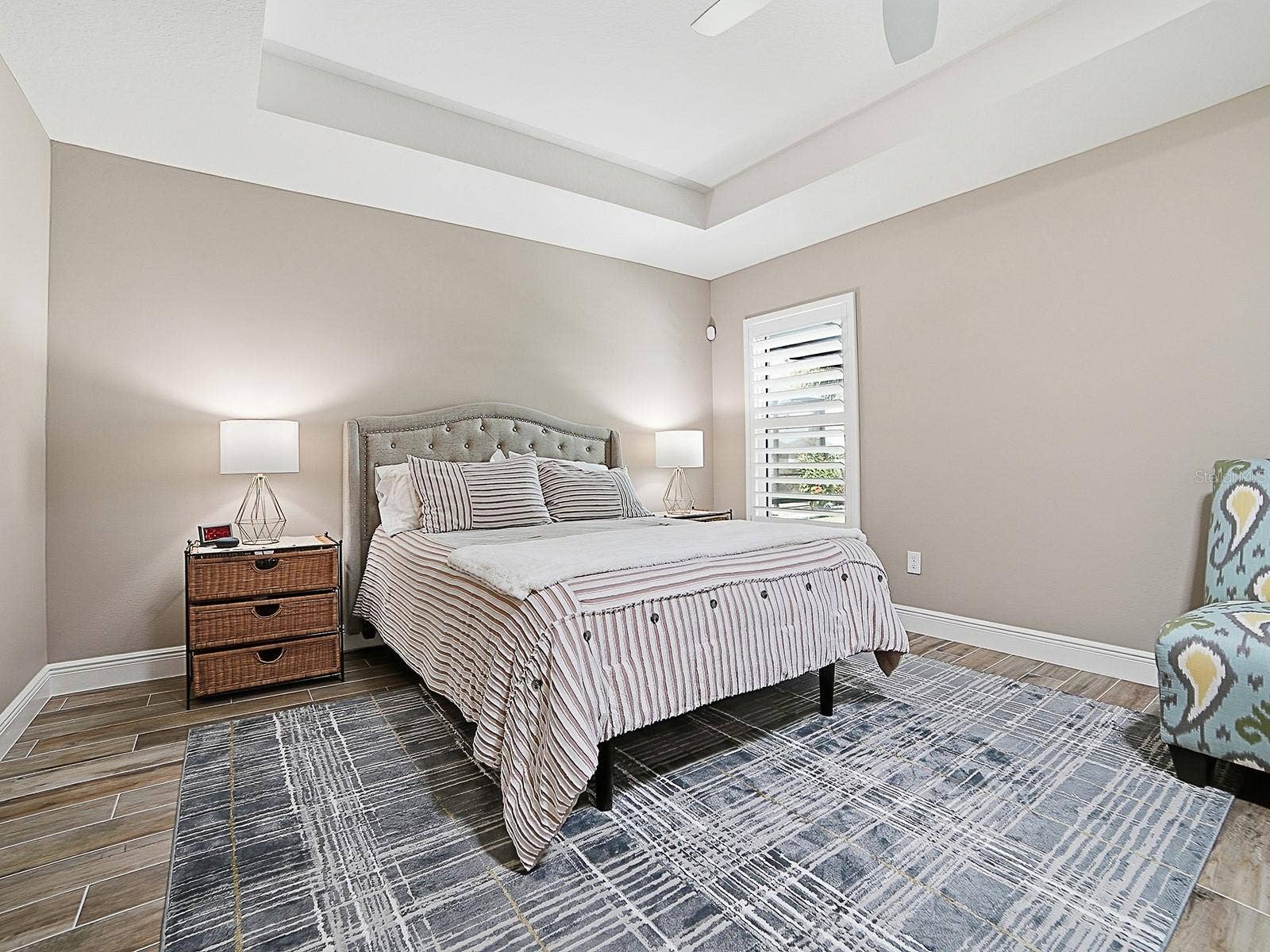 3075 LICCIARDELLO PATH, The Villages, FL 32163 PRIMARY BEDROOM WITH TRAY CEILING AND PLANTATION SHUTTERS.