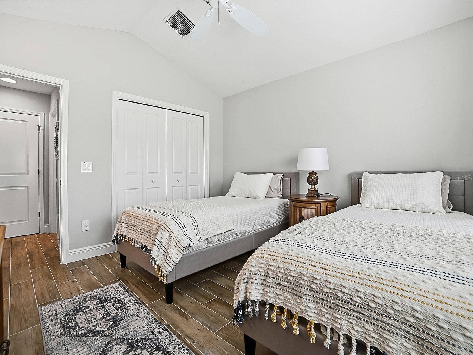 3075 LICCIARDELLO PATH, The Villages, FL 32163 THIS GUEST SUITE IS TO THE RIGHT OF THE FOYER WHEN YOU ENTER THE HOME. VAULTED CEILINGS AND DOUBLE DOOR CLOSET. LINEN CLOSET IN THE HALLWAY AND TO THE RIGHT IS THE GUEST BATH.