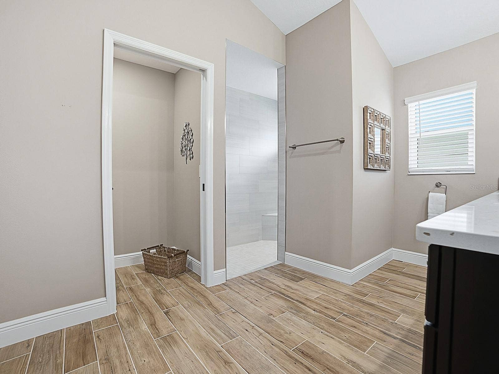 3075 LICCIARDELLO PATH, The Villages, FL 32163 POCKET DOOR TO THE PRIVATE TOILET ROOM AND ROMAN WALK-IN SHOWER TO THE RIGHT.