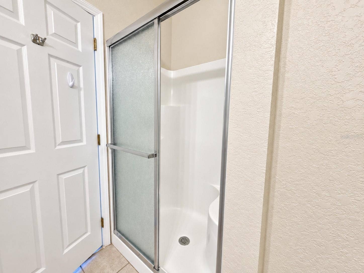 830 AIRPORT ROAD, #111, Port Orange, FL 32128 Primary Bathroom - walk-in shower with built in bench