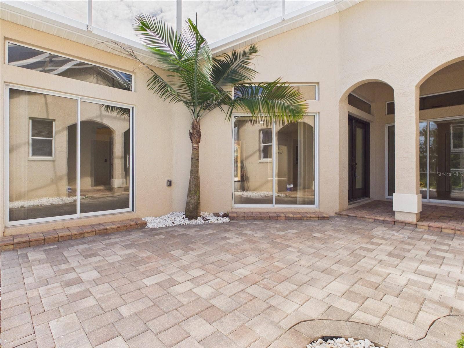 1802 ESTAFANA WAY, The Villages, FL 32159 screened courtyard with pavers and sliders