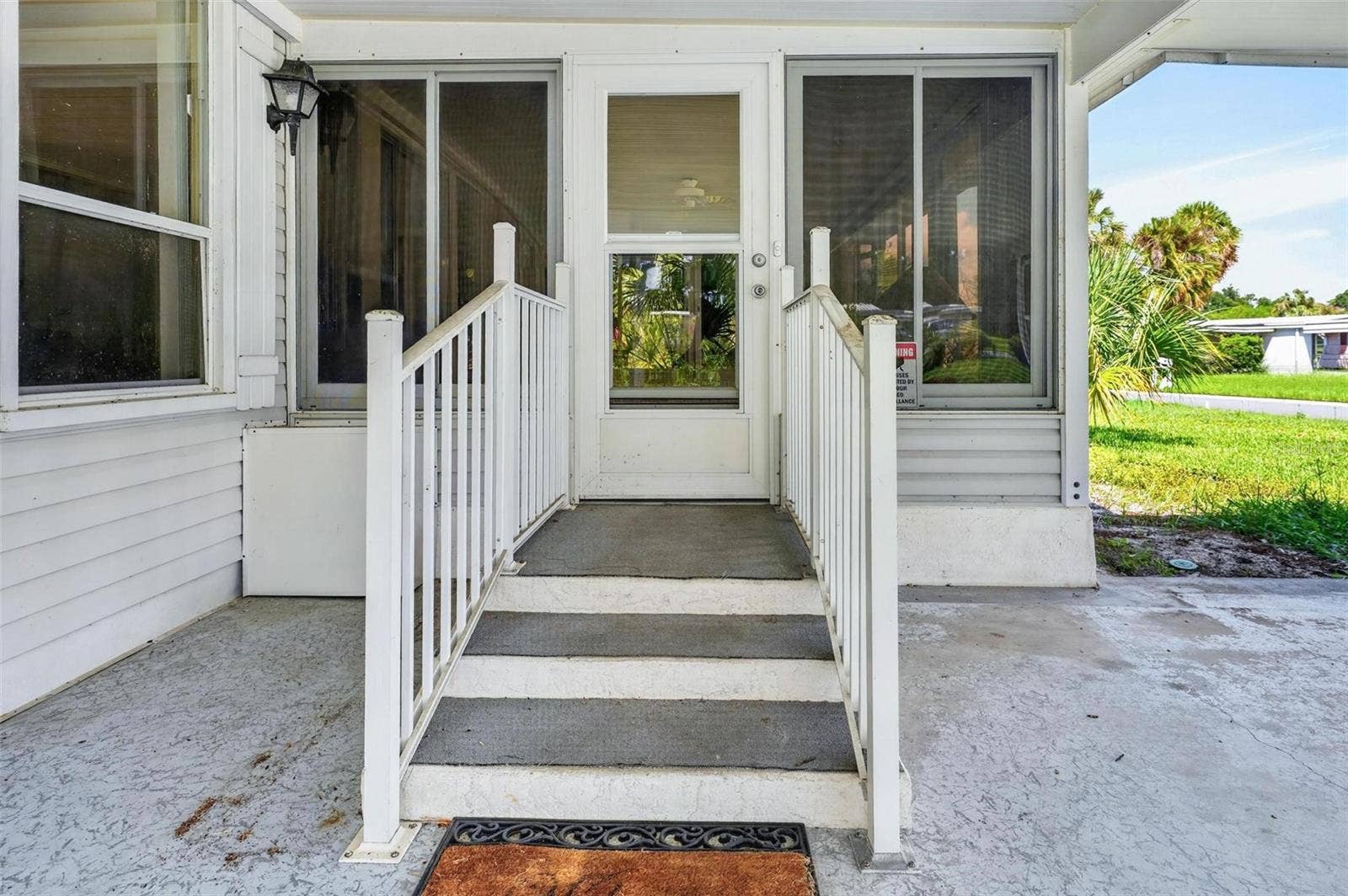 709 BENGAL AVENUE, Tavares, FL 32778 Carport Entry to Florida Room