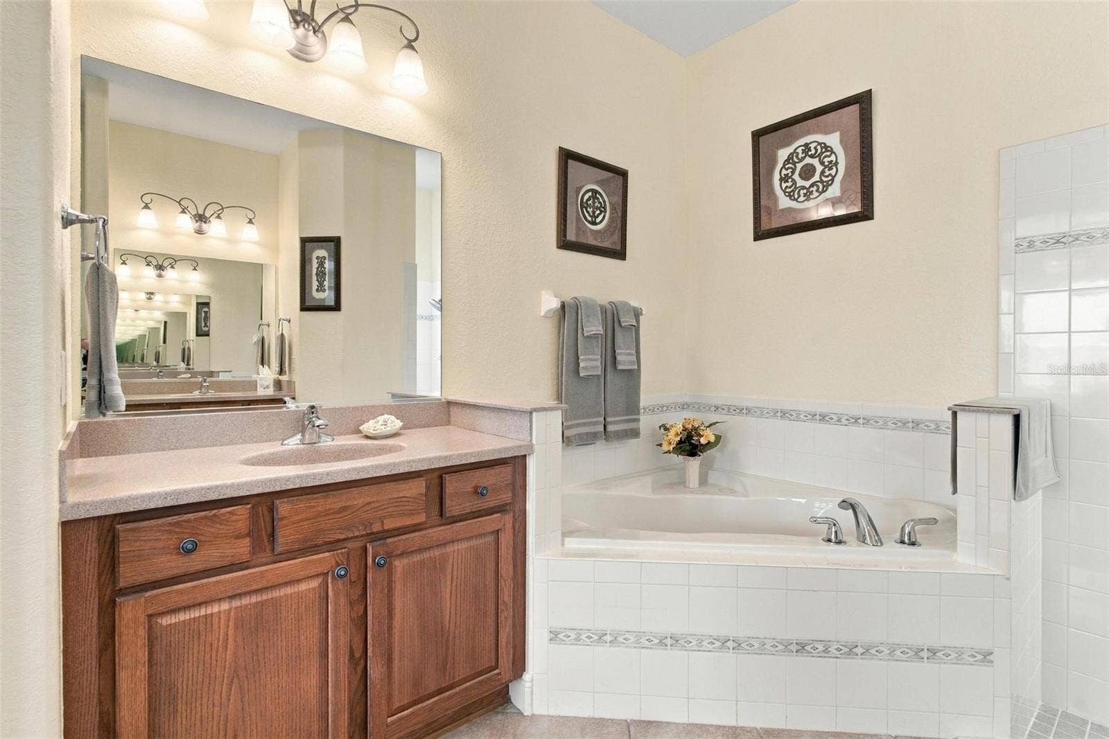 39118 GRIFFIN LANDING, Lady Lake, FL 32159 Primary bathroom with spa inspired soaking tub.