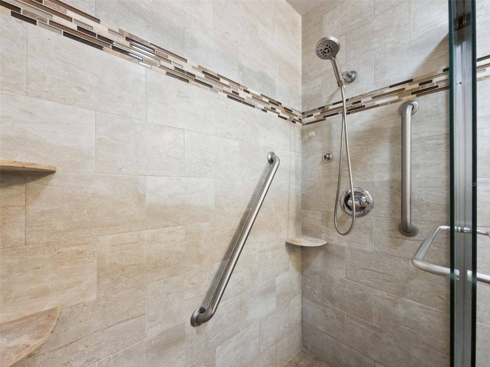 1066 VILLA LANE, #63, Apopka, FL 32712 Stunning en suite, glass-enclosed shower with floor-to-ceiling and designer linear tiles plus built-in shelves.