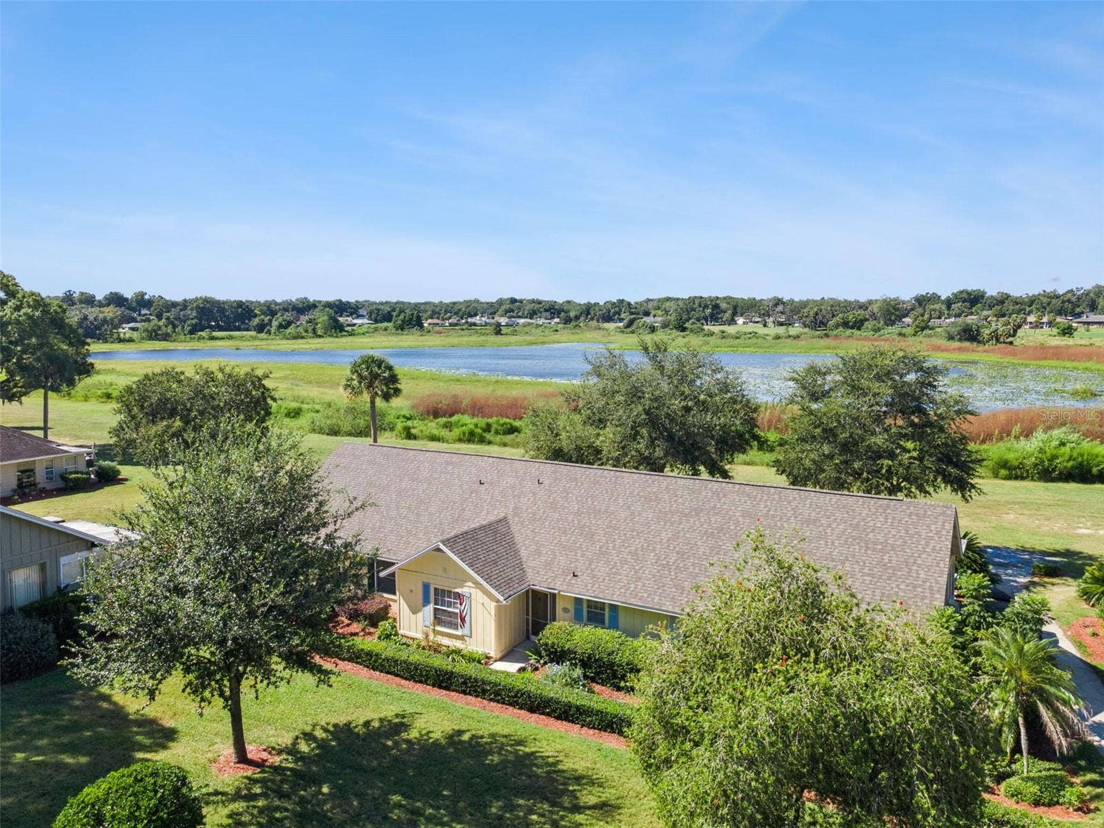 1066 VILLA LANE, #63, Apopka, FL 32712 Some homes have a view. This one has a nightly show of the setting sun.