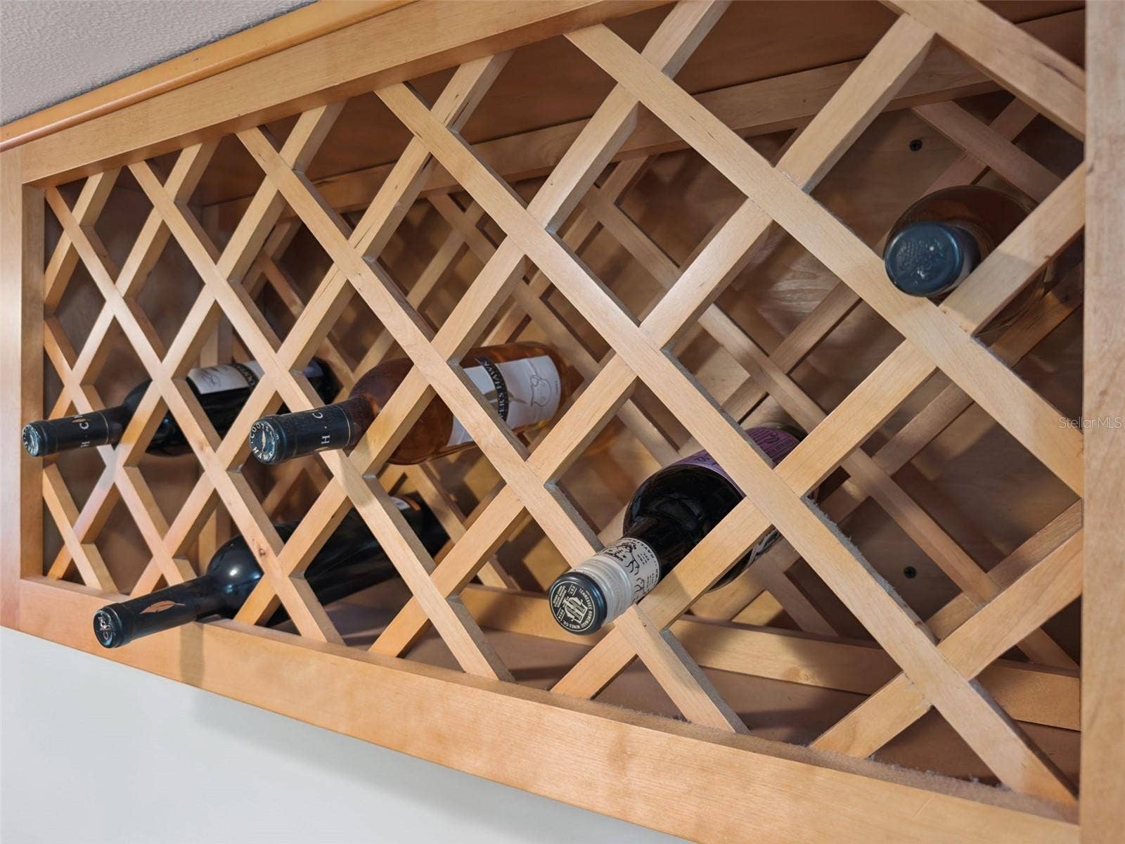 1066 VILLA LANE, #63, Apopka, FL 32712 Built-in wine rack matches the rich tones of the wood cabinets.