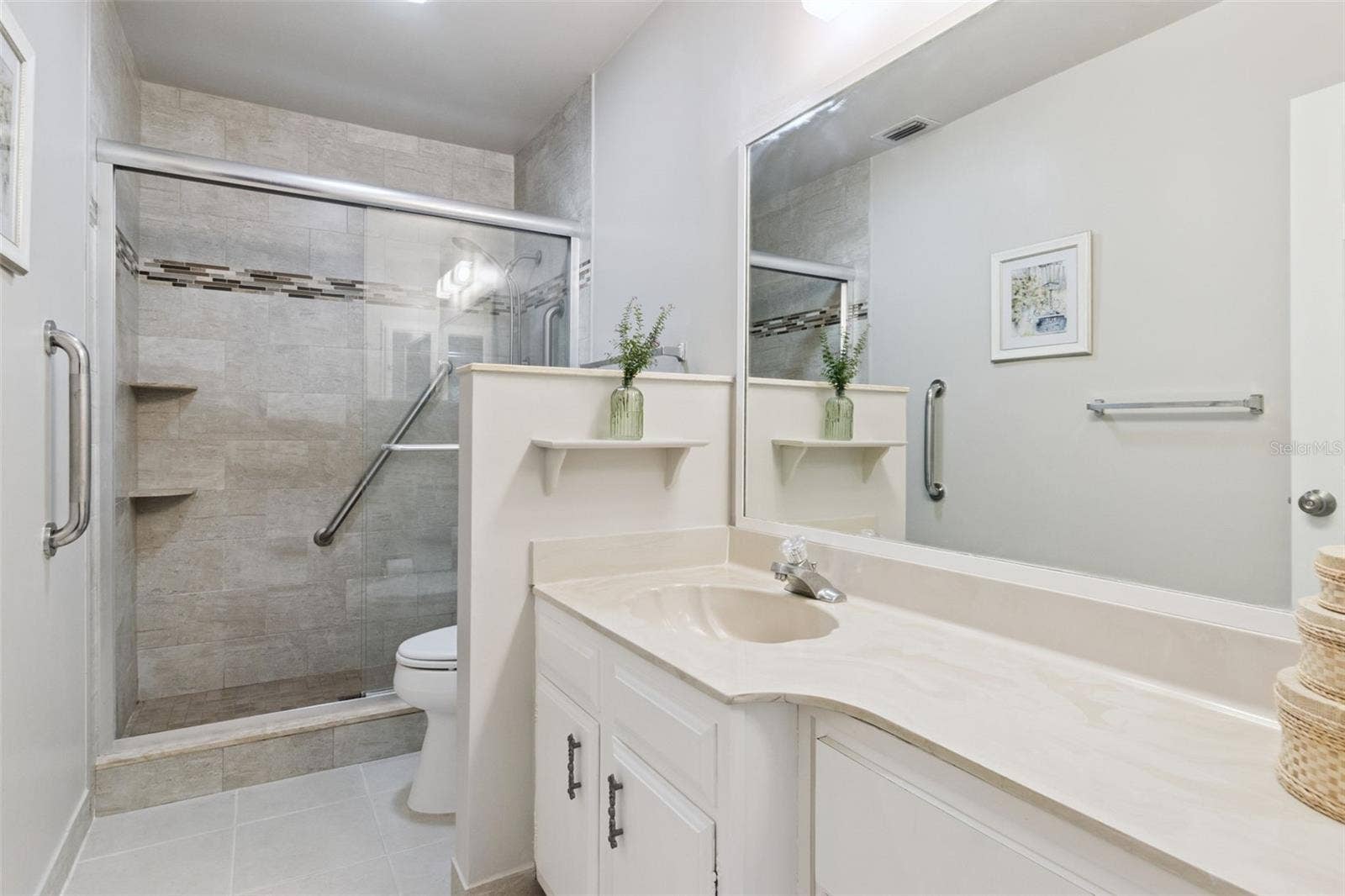 1066 VILLA LANE, #63, Apopka, FL 32712 Spacious en suite bath with wide marble vanity, multiple drawers and ceramic tile flooring.