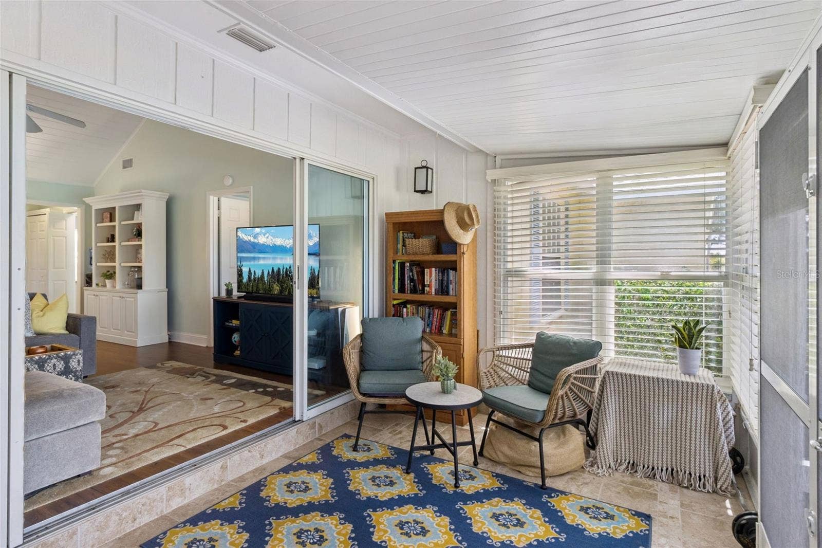 1066 VILLA LANE, #63, Apopka, FL 32712 Open the four-panel sliding glass doors to the sunroom.
