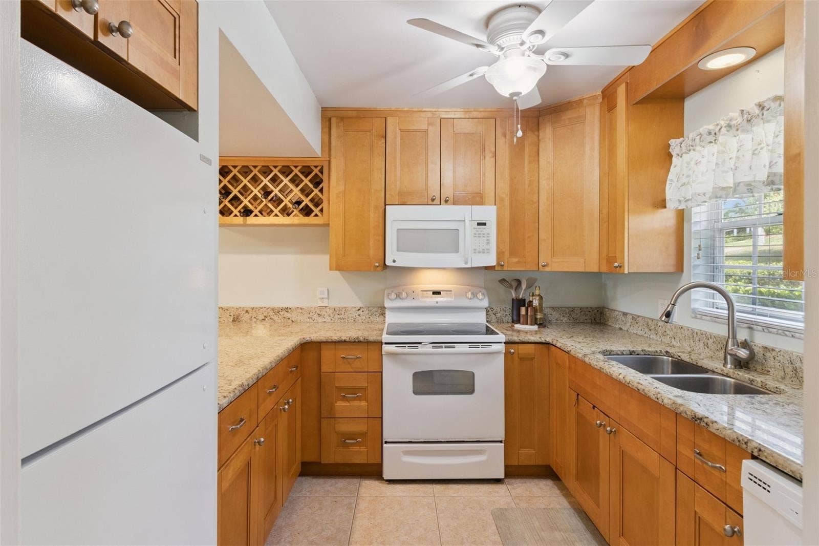 1066 VILLA LANE, #63, Apopka, FL 32712 Richly endowed with gorgeous granite counters and a wealth of wood cabinets make this kitchen fun and functional.