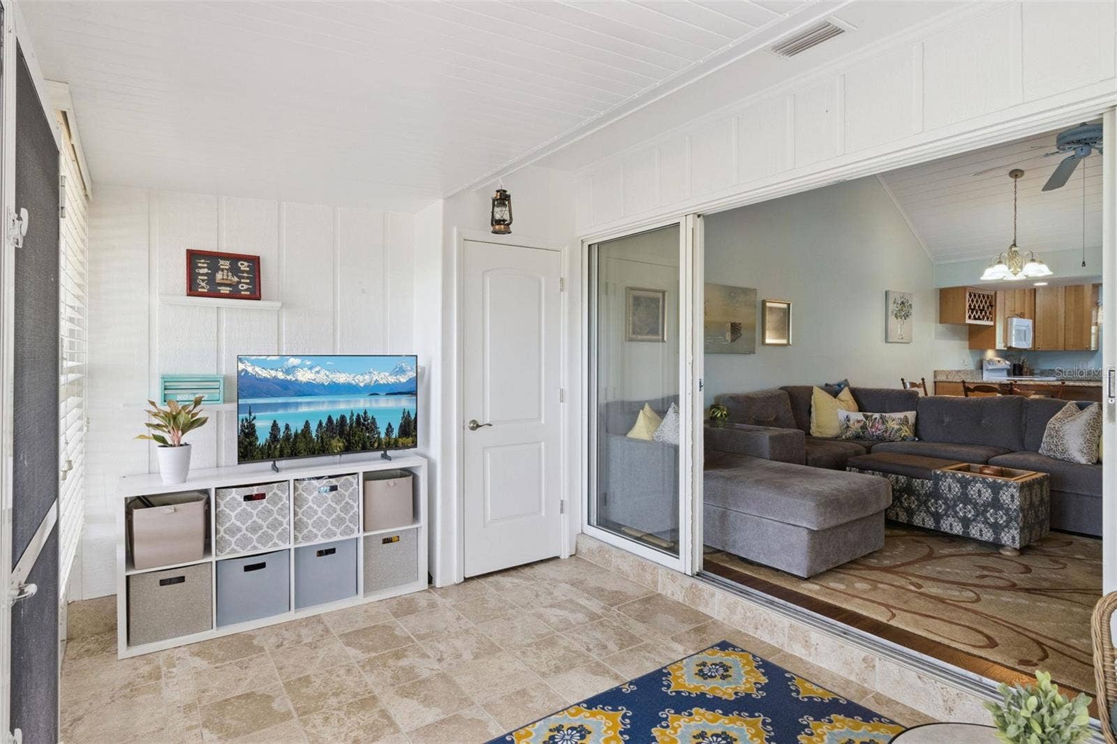 1066 VILLA LANE, #63, Apopka, FL 32712 Sunroom has stunning custom tile flooring and a handy storage closet.