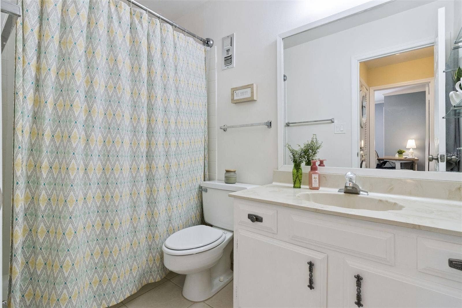 1066 VILLA LANE, #63, Apopka, FL 32712 The second bathroom features a marble vanity with integrated sink and tub with shower.
