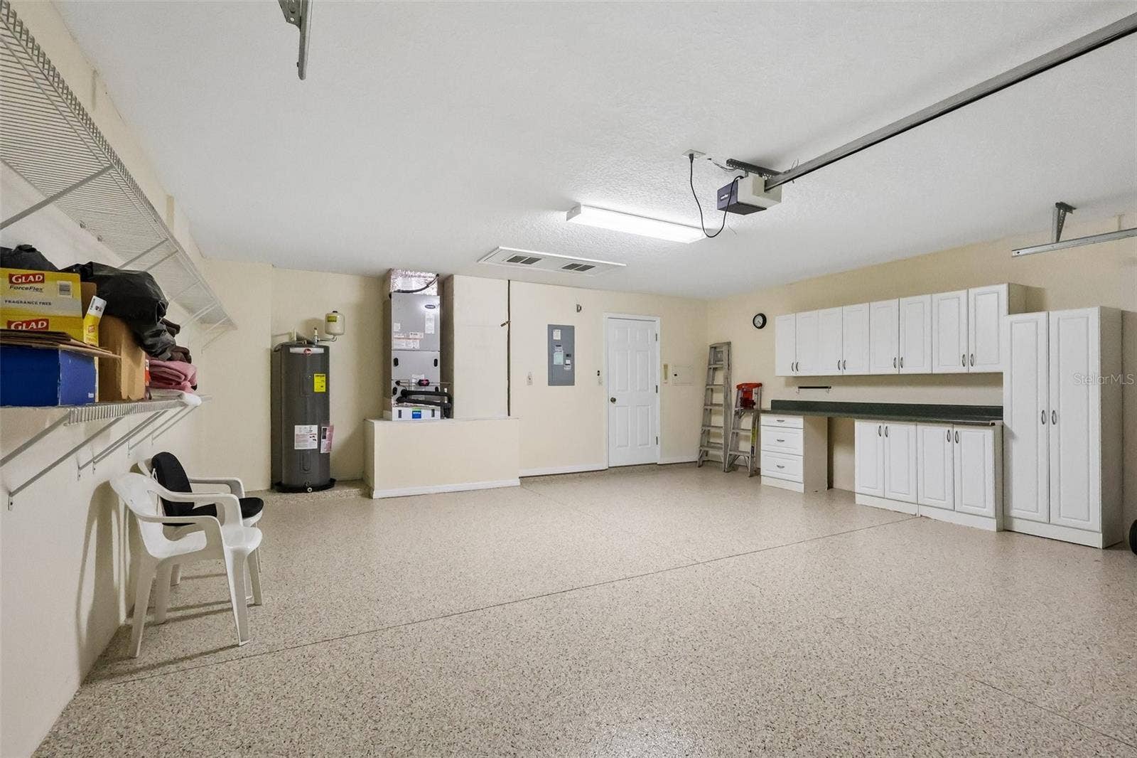 24445 MADEWOOD AVENUE, Leesburg, FL 34748 Freshly Painted Epoxy Garage Floor with Storage Cabinets and Workbench