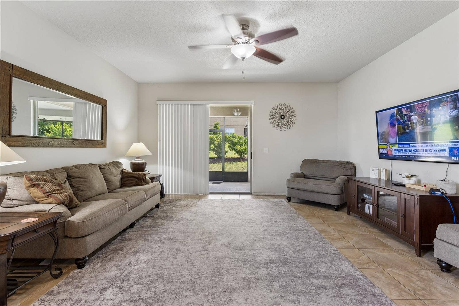 30022 DONNINGTON LOOP, Mount Dora, FL 32757 Spacious family room with doors leading out to the covered lanai and patio.