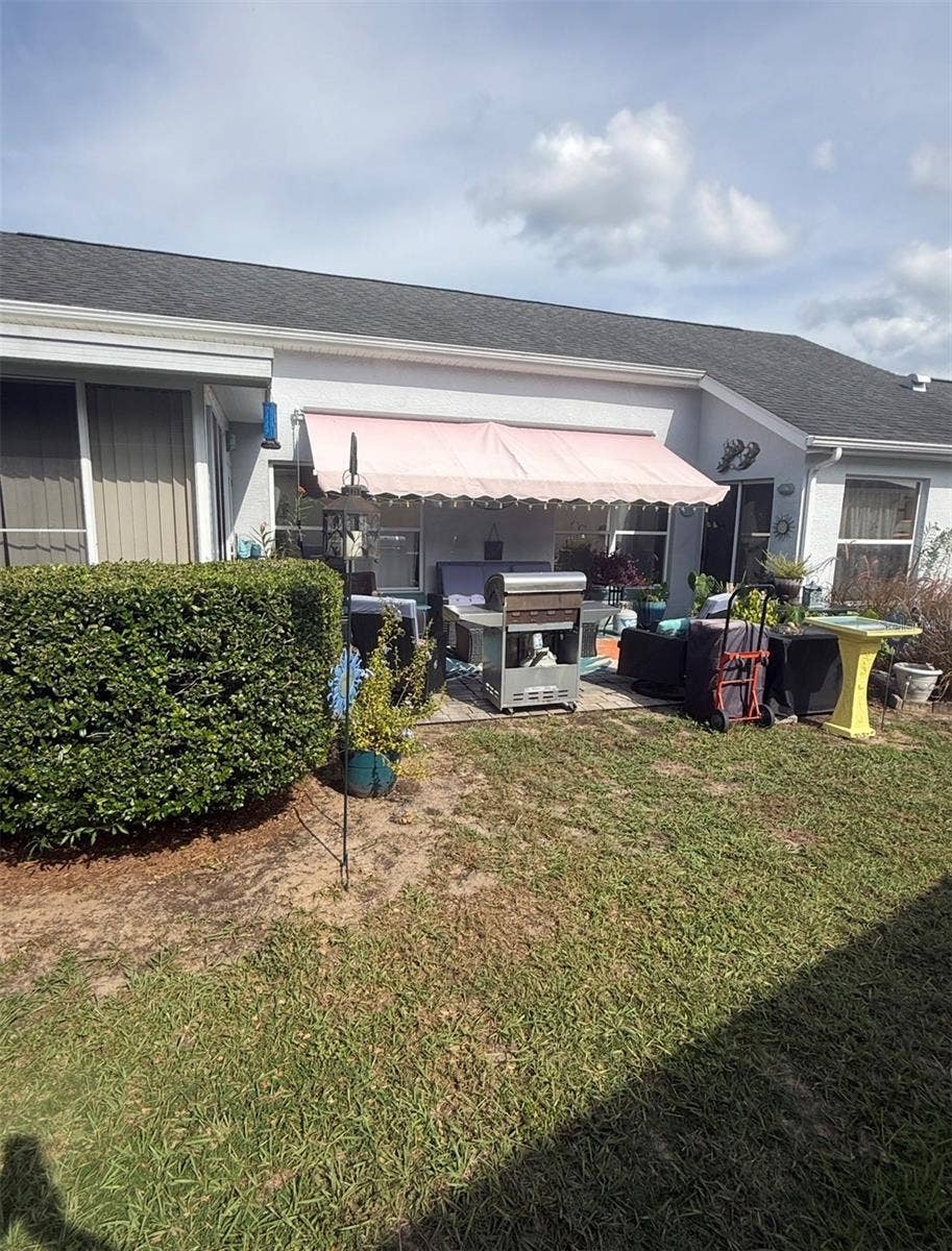 10440 S CLINT LOOP, Floral City, FL 34436 other side yard with grilling and relaxing area under sun shade