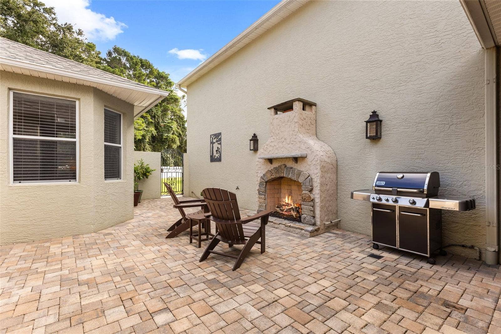 4711 HERITAGE TRAIL, Leesburg, FL 34748 Private Courtyard with Outdoor Gas Fireplace, Paver Patio & 2 Custom Copper Gas Lanterns