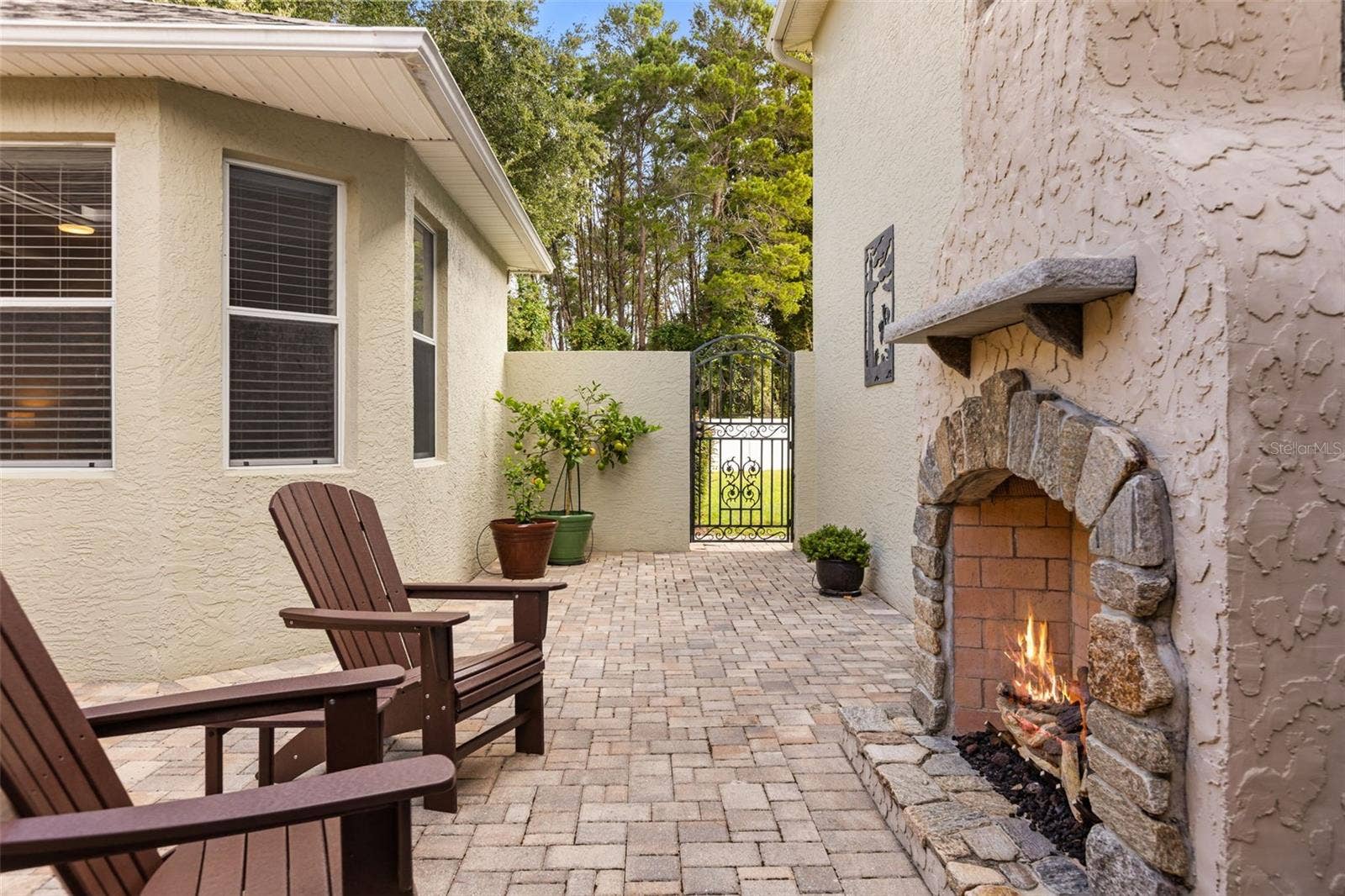 4711 HERITAGE TRAIL, Leesburg, FL 34748 Private Courtyard with Stone Gas Fireplace, Paver Patio & 2 Handmade Copper Gas Lanterns