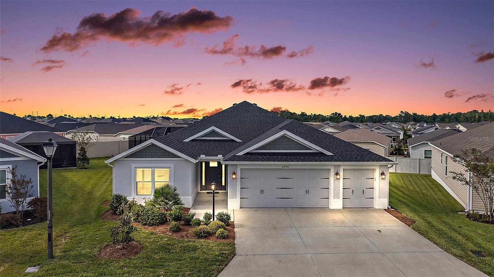 6996 DWIGHT DRIVE, The Villages, FL 34762 Twilight Front Elevation