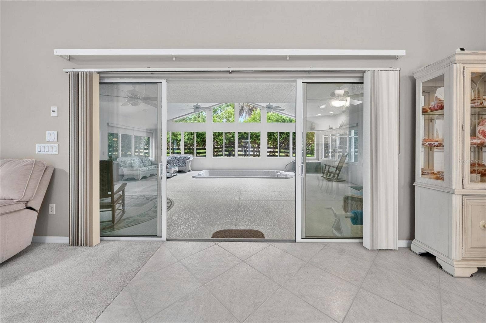 9245 SE 169TH BENTLEY STREET, The Villages, FL 32162 LIVING ROOM TO ENCLOSED LANAI