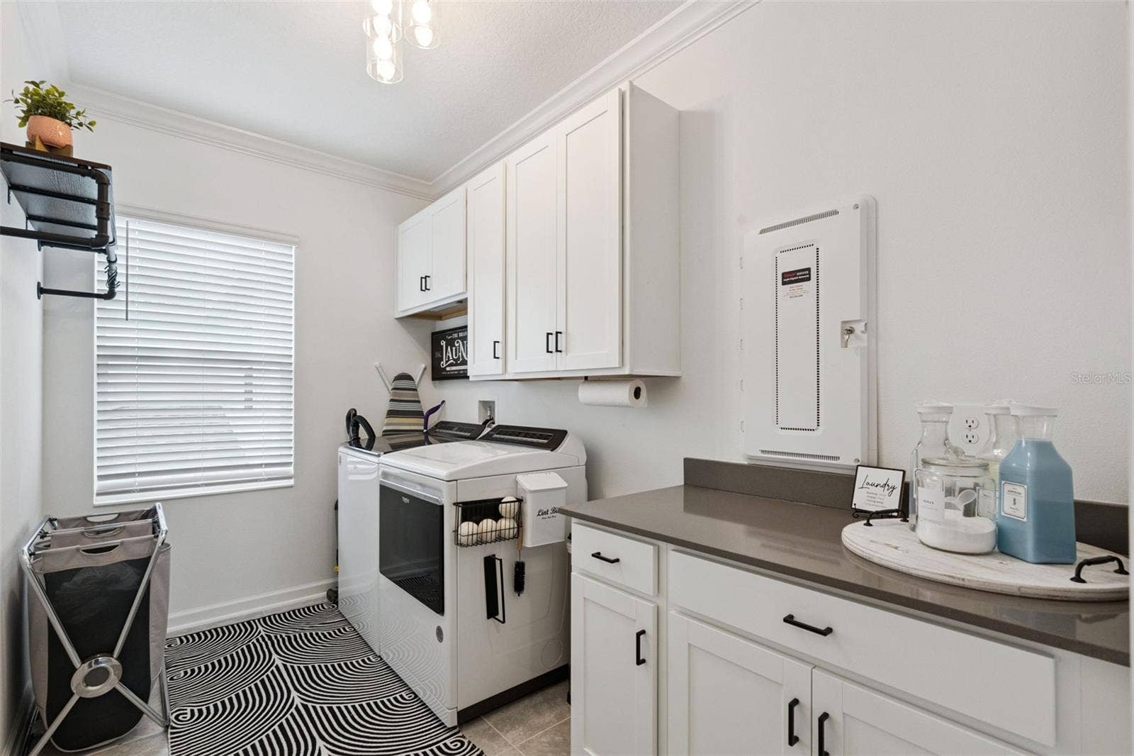 6175 SHAVASANA RD ROAD, Clermont, FL 34714 2nd floor oversized laundry room adjacent to owner's suite with stone counter top and plenty of cabinet space