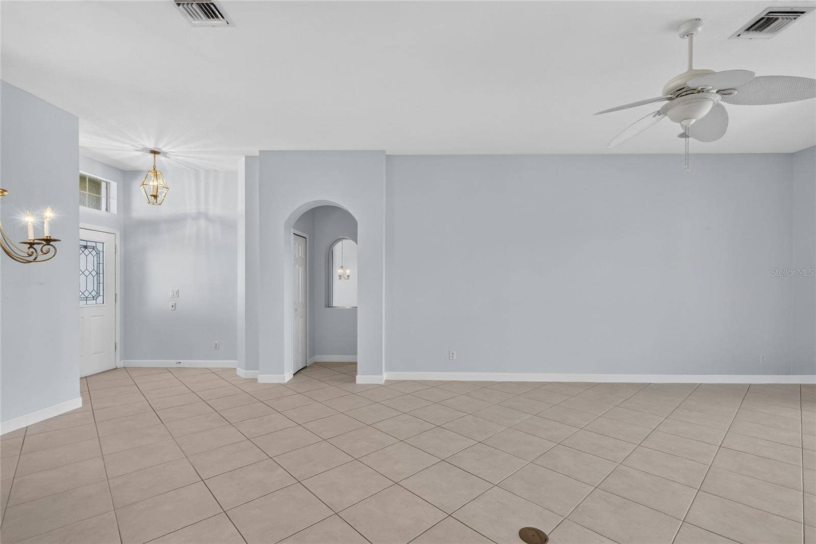 The 18" square ceramic tile is set on the diagonal throughout dining, living and kitchen.  Access to the primary bedroom is off the foyer.