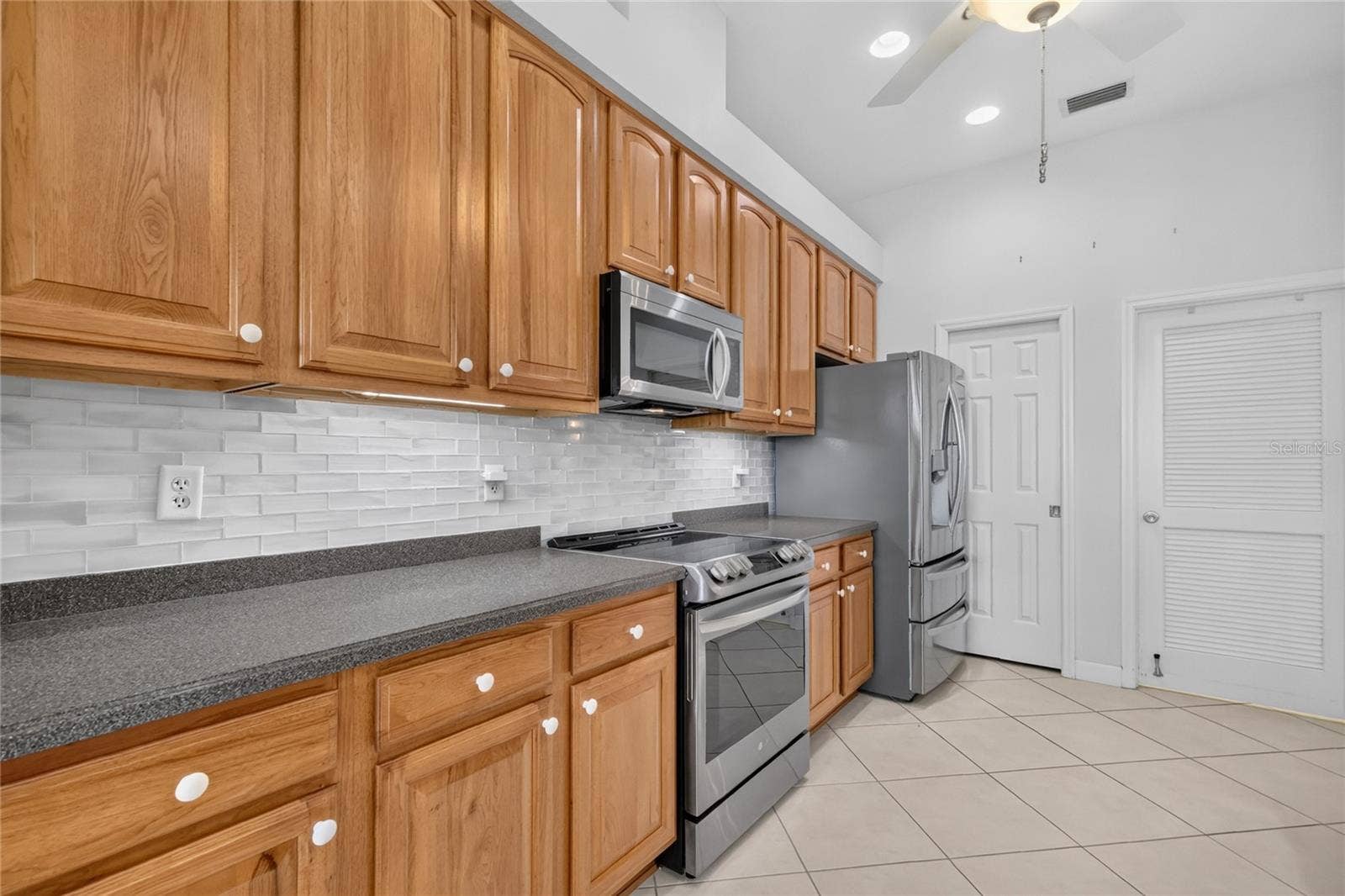 The beautiful glass tile backsplash and long countertops will make any chef happy.