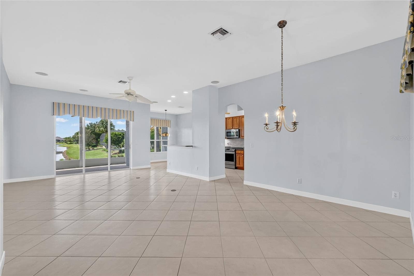 Step from the foyer into the large great room where you can see the dining room, living room and kitchen.