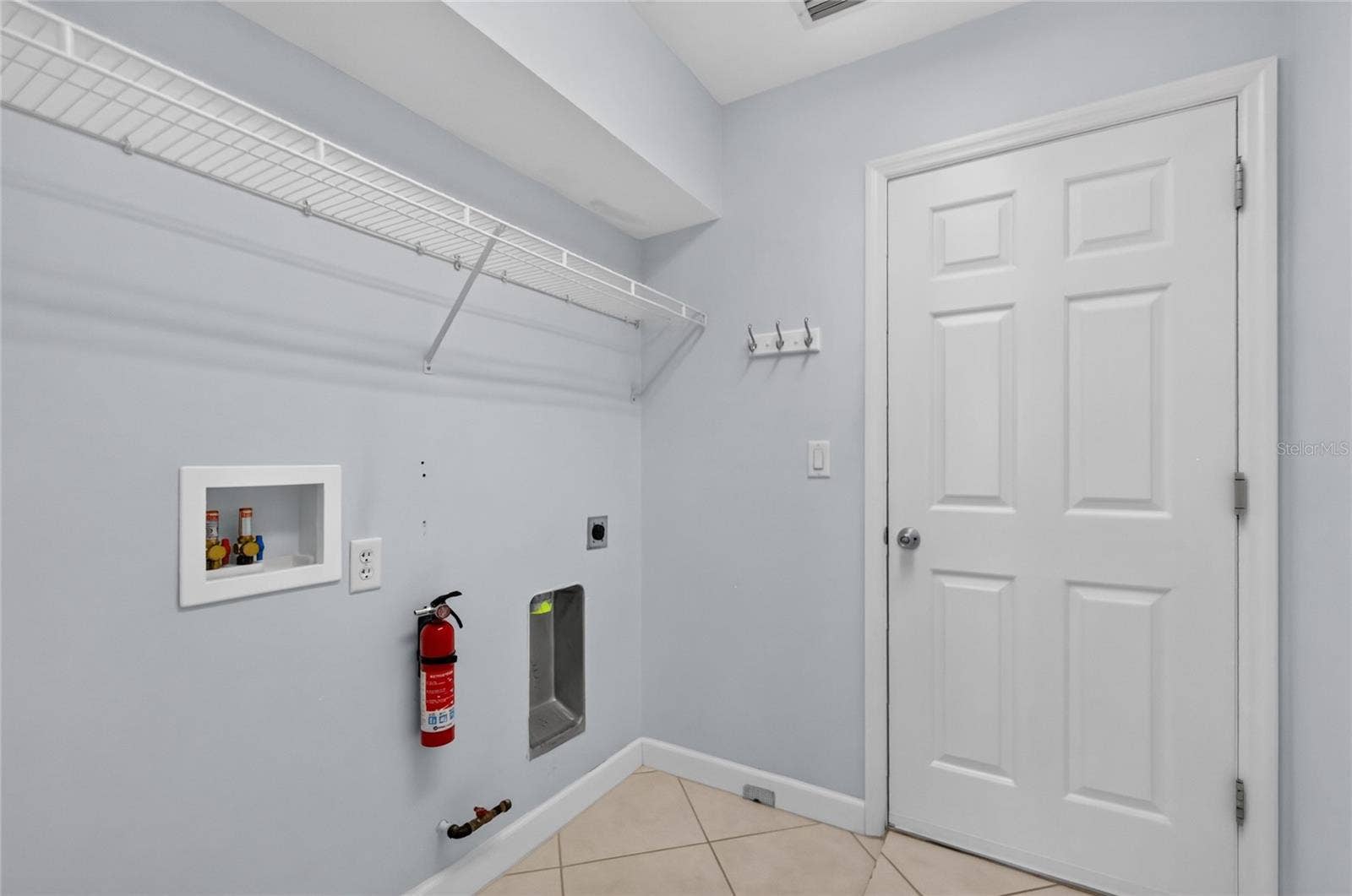 The inside laundry room has some additional storage and provides access to the garage.