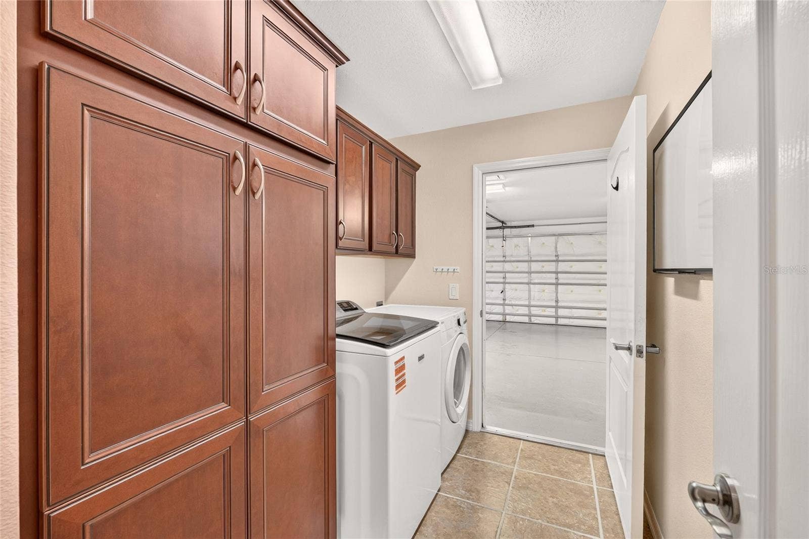 2454 MORNING DOVE LANE, The Villages, FL 32162 A TWO-CAR PLUS GOLF CART GARAGE offers ample parking, with a programmable, app-controlled garage door opener and camera for convenient remote access and monitoring from wherever you are.