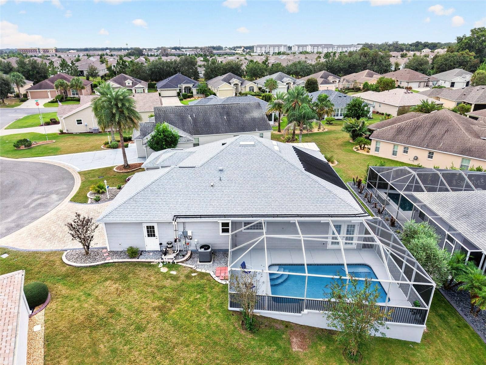 2454 MORNING DOVE LANE, The Villages, FL 32162 This aerial view showcases the SCREENED POOL RETREAT, SOLAR POOL HEATING PANELS, and spacious backyardoffering plenty of room to enjoy the Florida sunshine!
