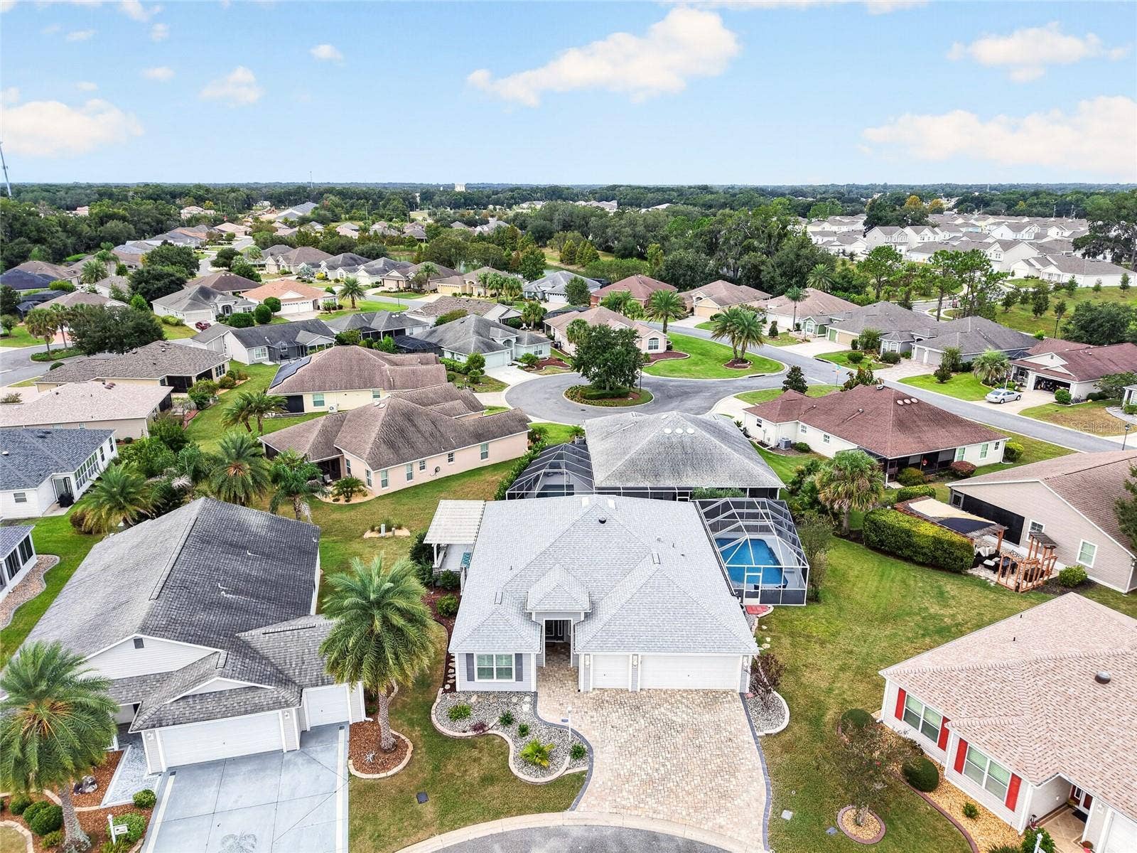 2454 MORNING DOVE LANE, The Villages, FL 32162 A birds-eye view captures this inviting homes SCREENED POOL and surrounding neighborhood, with palm-lined streets setting the scene for THE VILLAGES LIFESTYLE!