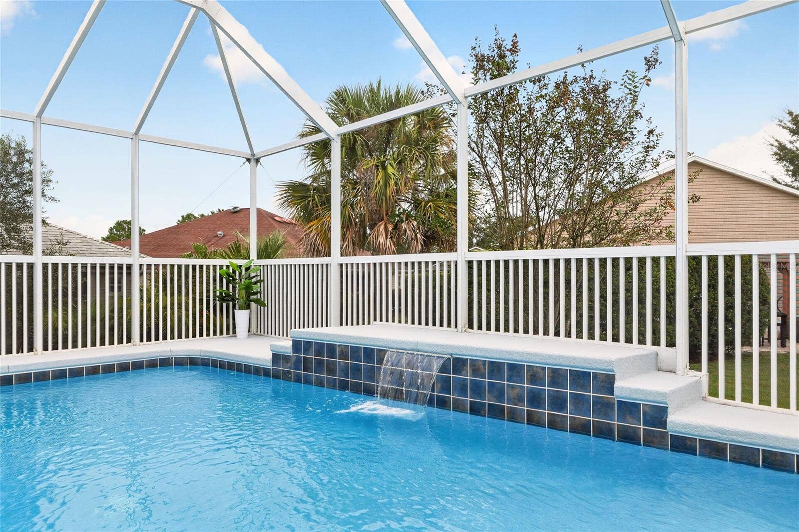 2454 MORNING DOVE LANE, The Villages, FL 32162 Enjoy a refreshing dip in the sparkling pool while the soothing waterfall creates a relaxing retreat beneath the spacious screened birdcage.