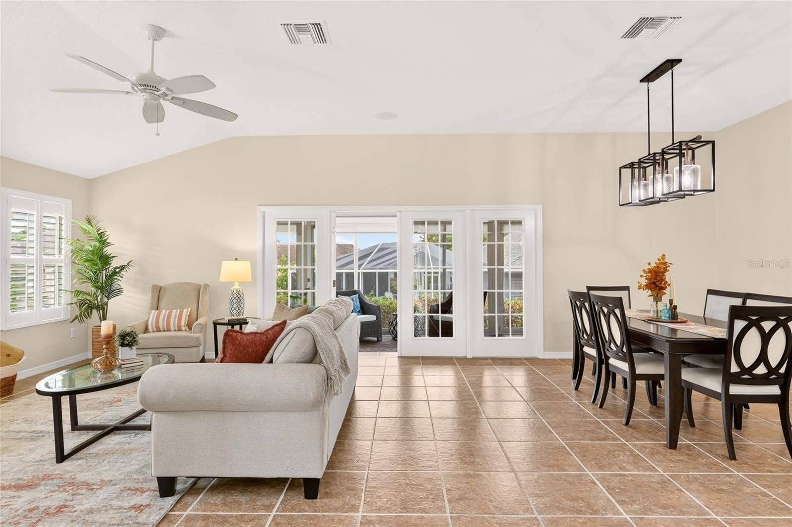 2454 MORNING DOVE LANE, The Villages, FL 32162 An inviting OPEN LIVING AREA flows seamlessly into the kitchen and dining space, creating a welcoming setting for entertaining, conversation, and everyday relaxation.
